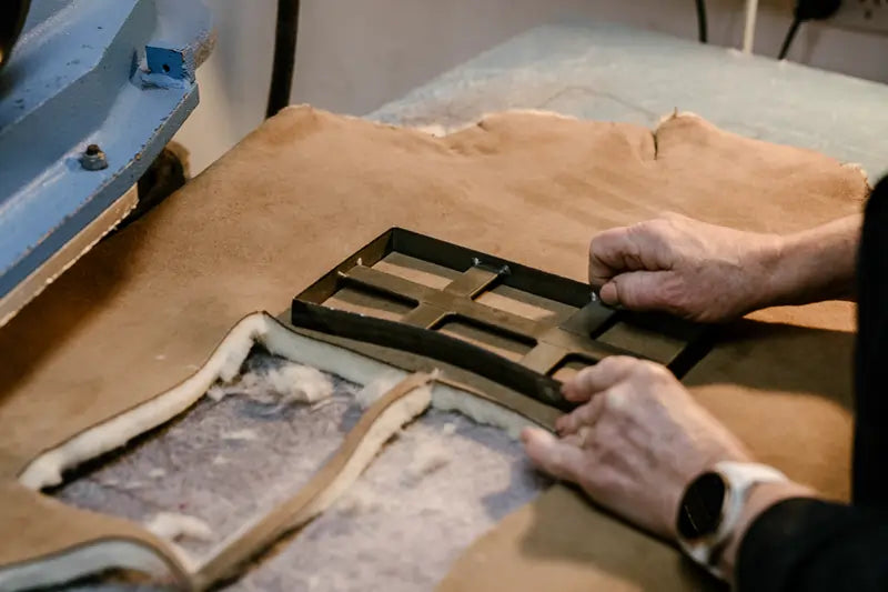 Jassi worker cutting pieces of australian sheepskin to handcraft ugg boots.