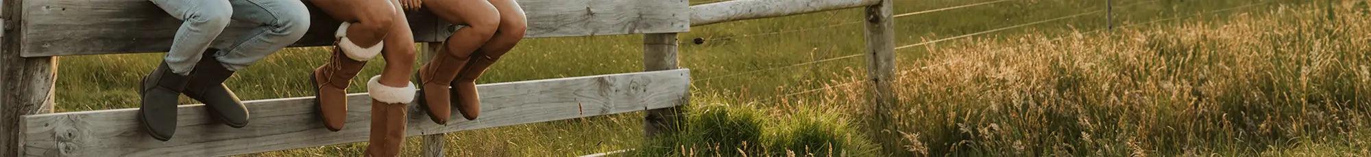 3 friends sitting on a fence wearing short olive uggs, long lace-up tan ugg boots and mid suede tan uggies.