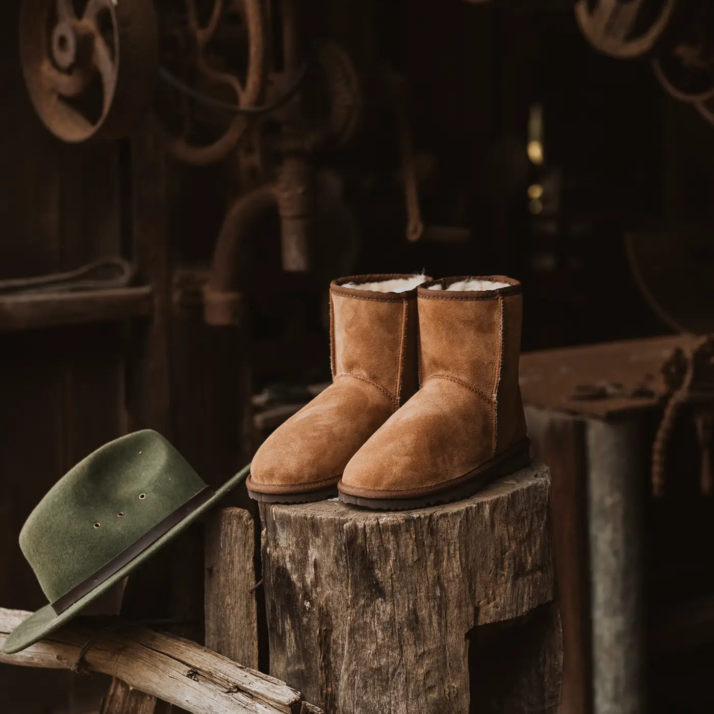 Pair of handmade classic ugg boots on tan color.