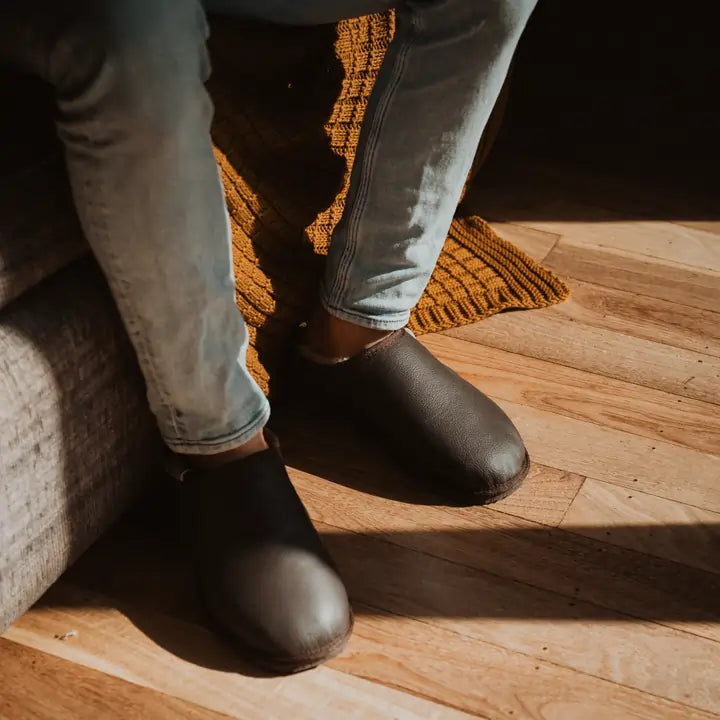 Close up of man on jeans wearing Jassi ugg Leather mewels in chocolate color. #color_chocolate