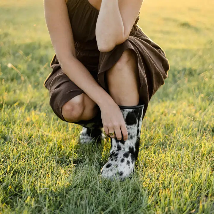 Close up of woman on a brown dress wearing the Jassi special edition cowhide ugg boots.