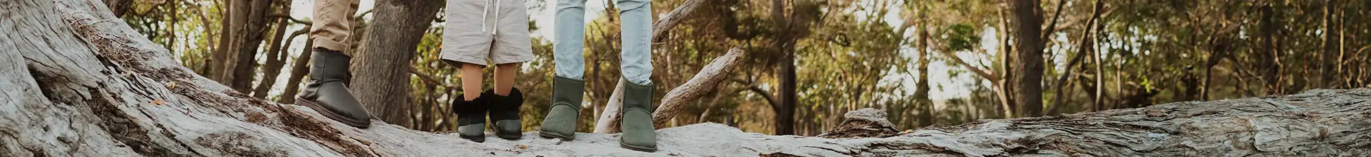 Two men and a little boy wearing short leather chocolate ugg boots, toddler black suede uggs and short suede olive ugg boots.