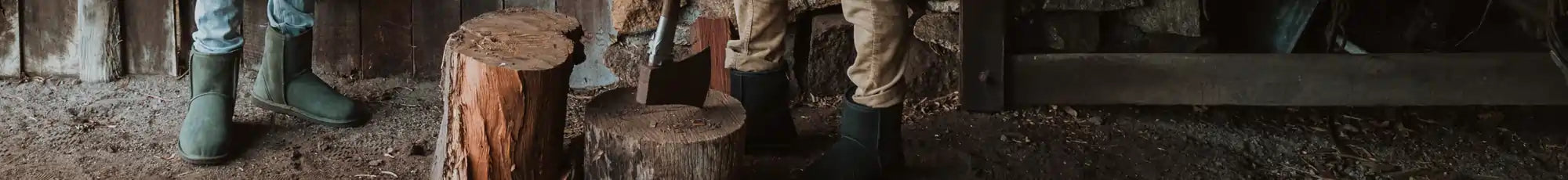 Two men chopping wood in short suede olive and black ugg boots.