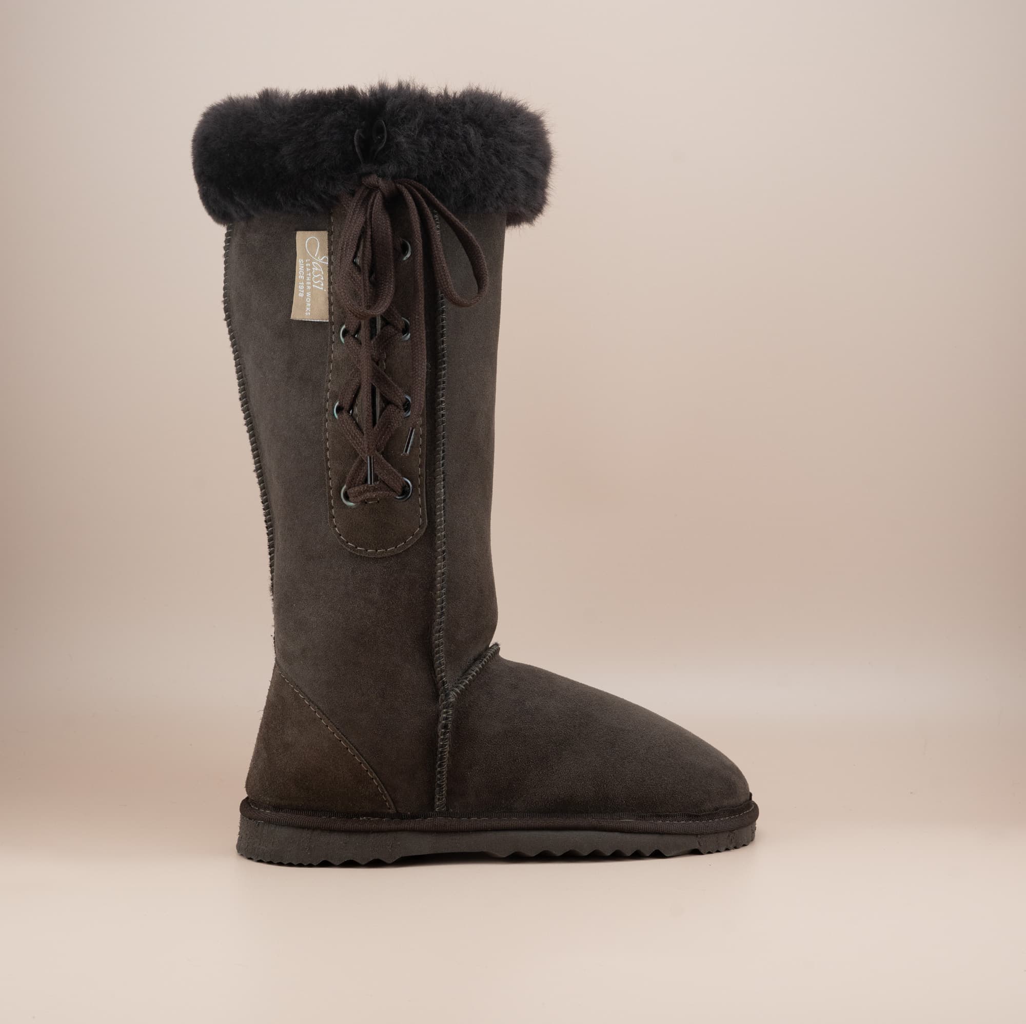 Men's long lace-up ugg boot in color chocolate and soft suede finish with signature wool turn, side view. #color_chocolate