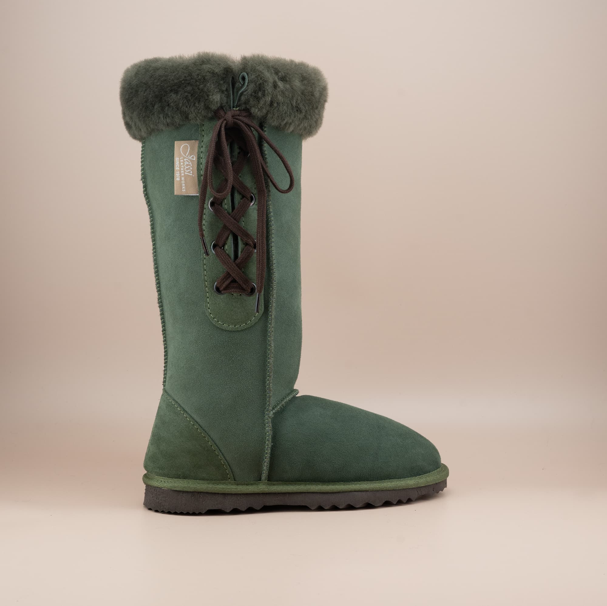 Men's long lace-up ugg boot in color olive and soft suede finish with signature wool turn, side view. #color_olive