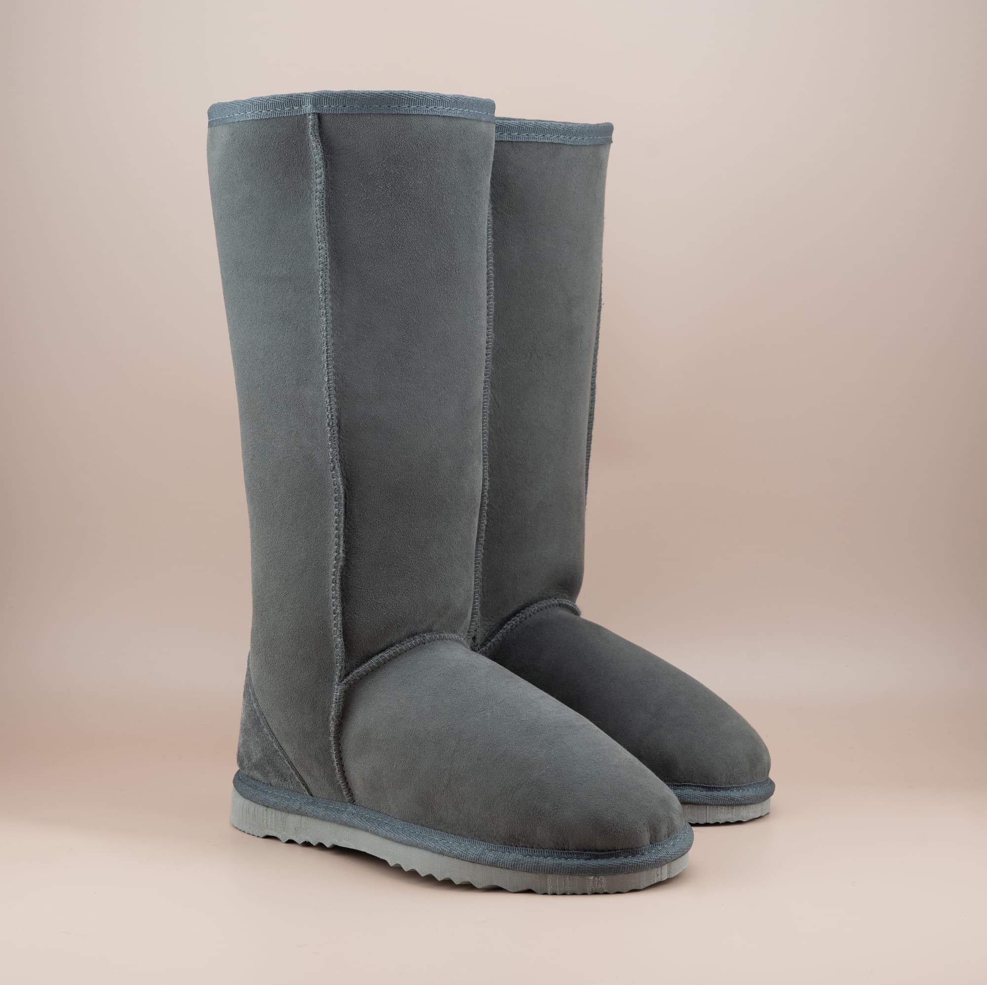 Men's long ugg boot in color grey and soft suede finish, front side view. #color_grey