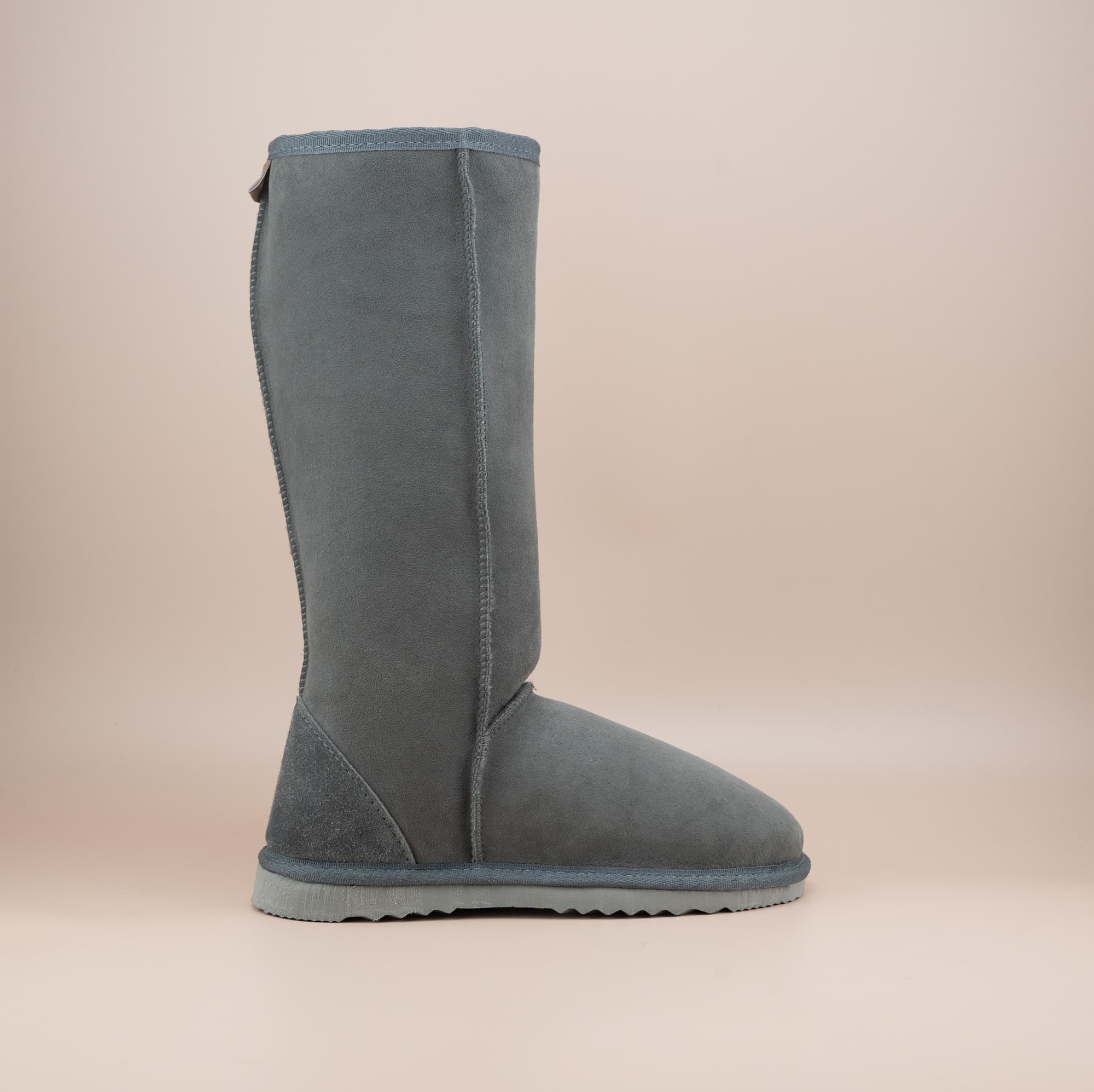 Men's long ugg boot in color grey and soft suede finish, side view. #color_grey