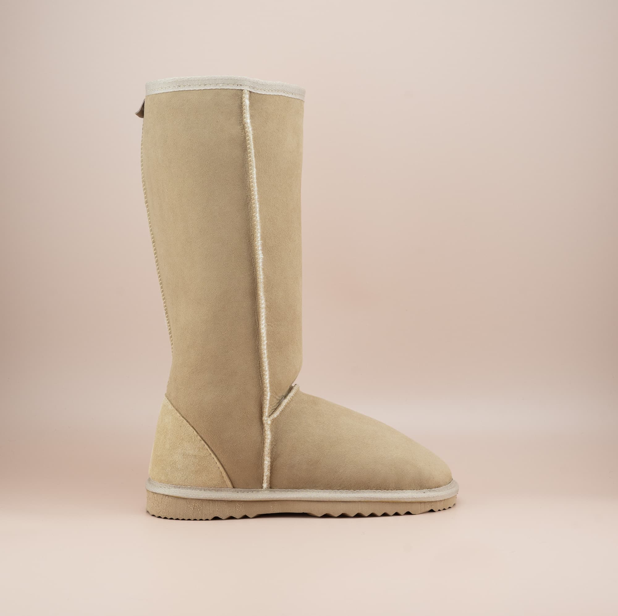 Men's long ugg boot in color sand and soft suede finish, side view. #color_sand