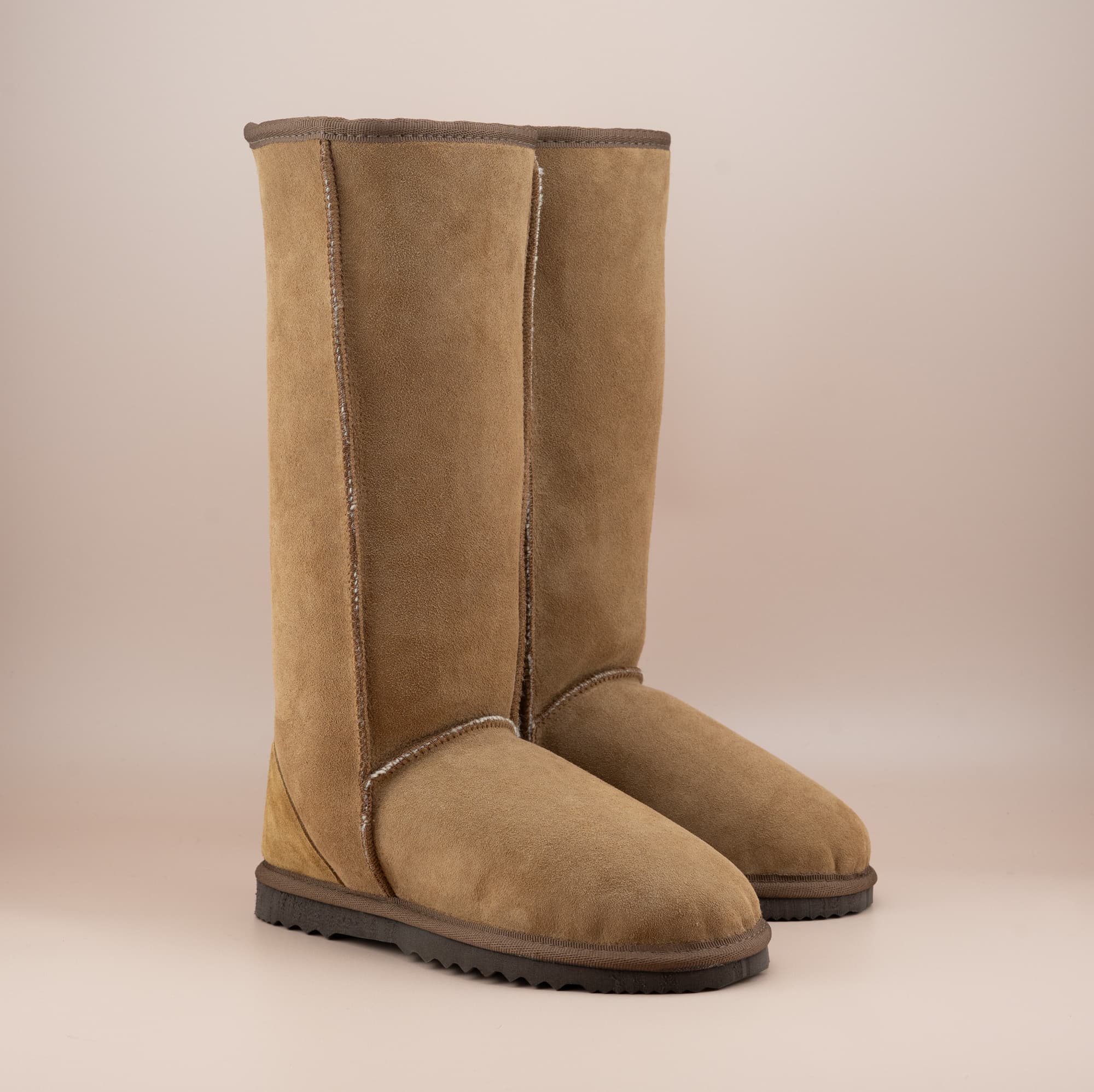 Men's long ugg boot in color tan and soft suede finish, front side view. #color_tan