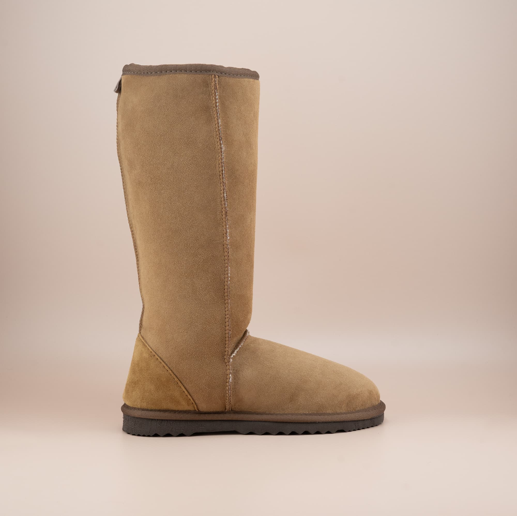 Men's long ugg boot in color tan and soft suede finish, side view. #color_tan