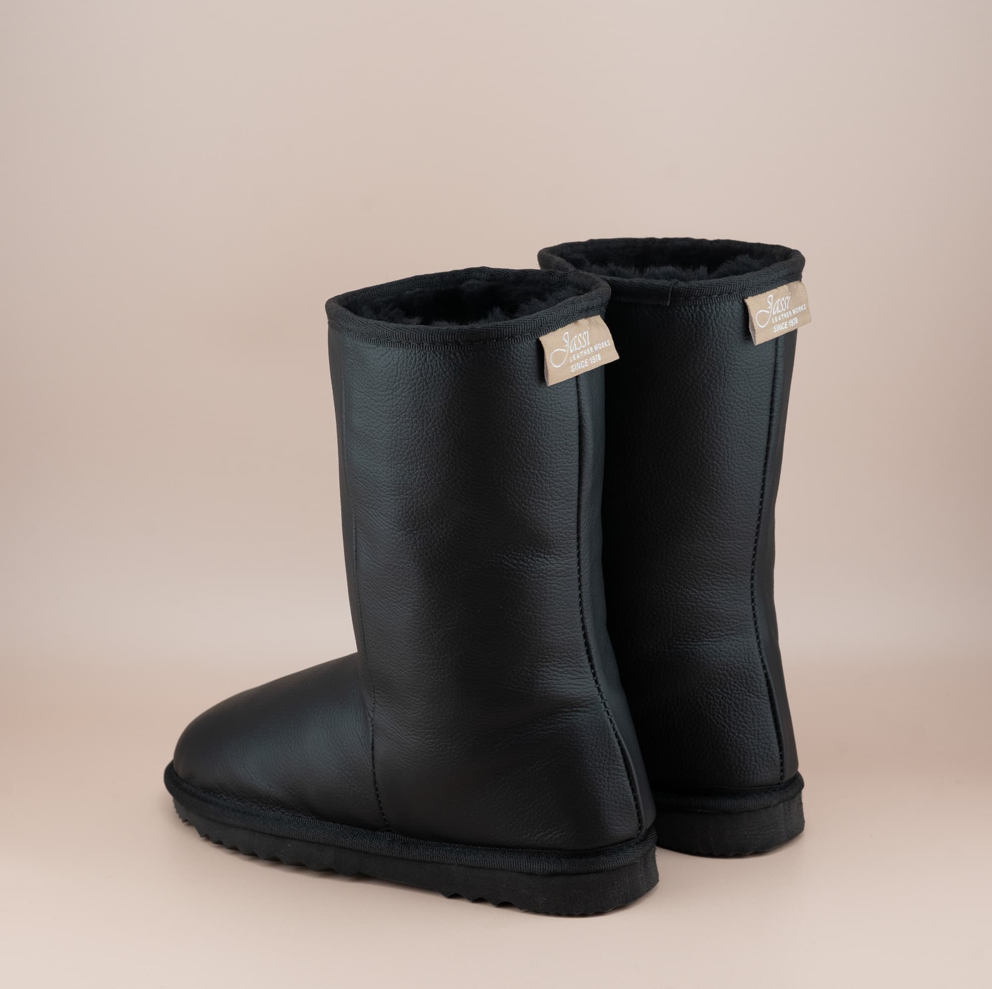 Men's Classic mid ugg boots in genuine leather finish and black color, back view. #color_leather black