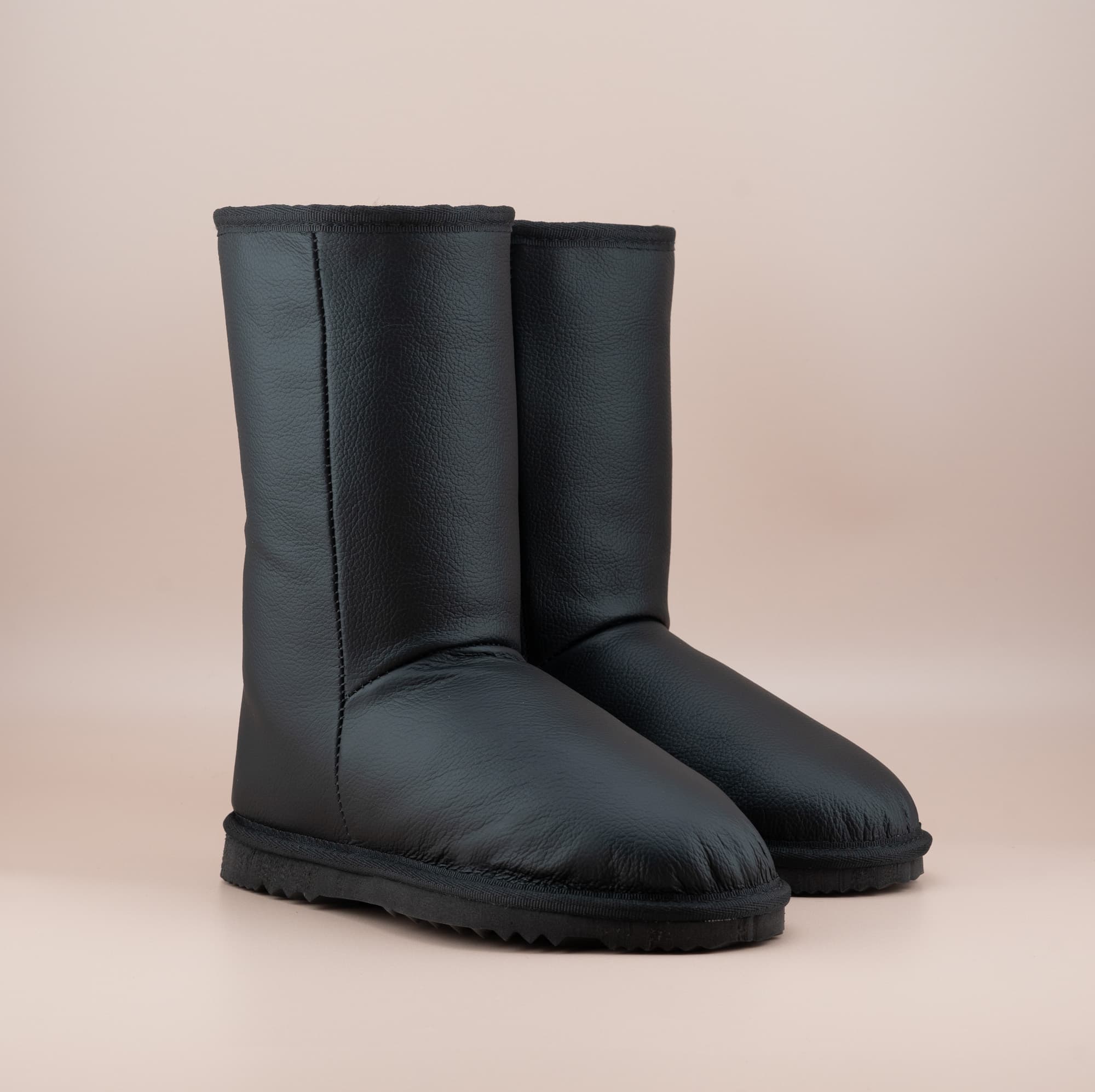 Men's Classic mid ugg boots in genuine leather finish and black color, front side view. #color_leather black