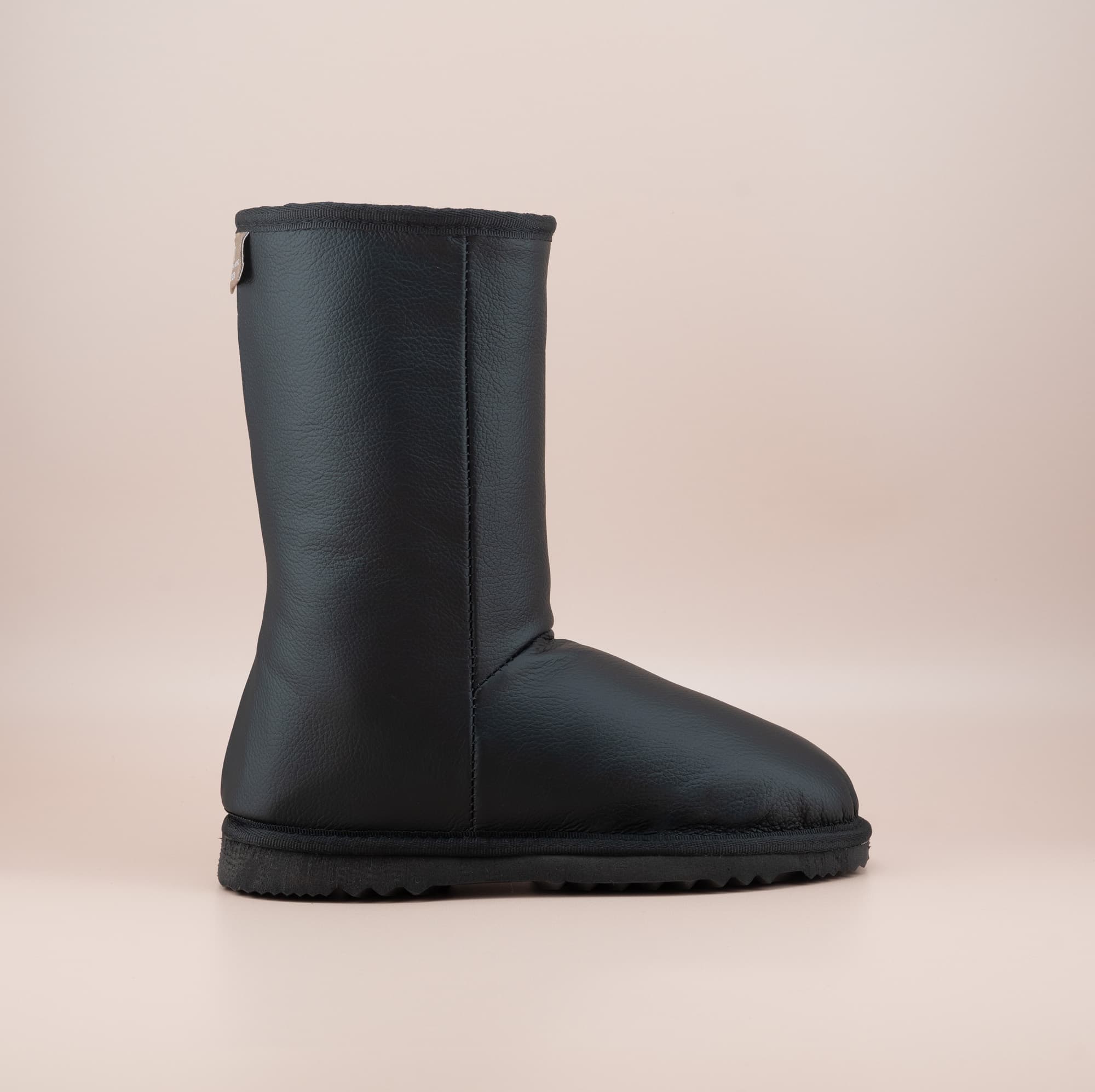 Men's Classic mid ugg boots in genuine leather finish and black color, side view. #color_leather black