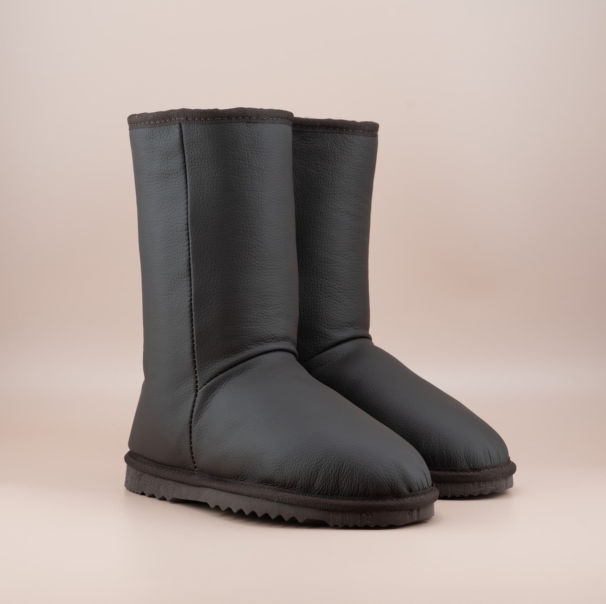 Men's Classic mid ugg boots in genuine leather finish and chocolate color, front side view. #color_leather chocolate