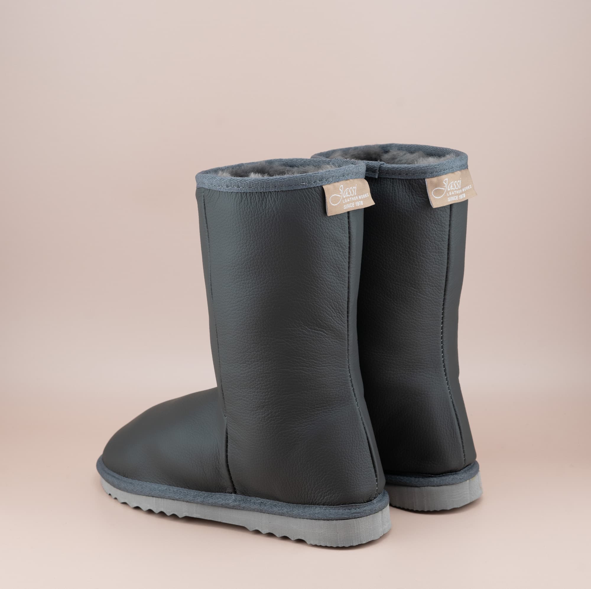 Men's Classic mid ugg boots in genuine leather finish and grey color, back view. #color_leather grey