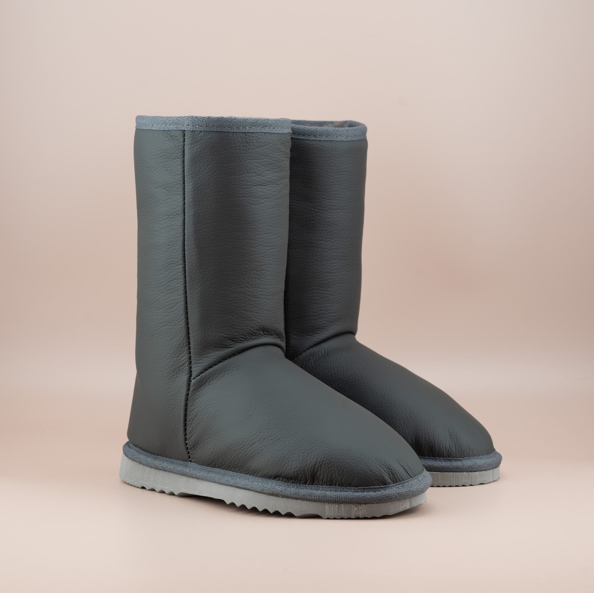 Men's Classic mid ugg boots in genuine leather finish and grey color, front side view. #color_leather grey