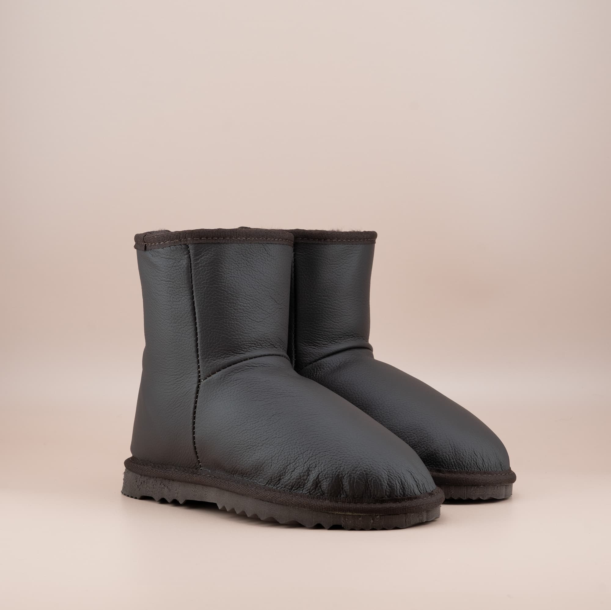 Men's Classic Short ugg boots in genuine leather finish and chocolate color, front side view. #color_leather chocolate