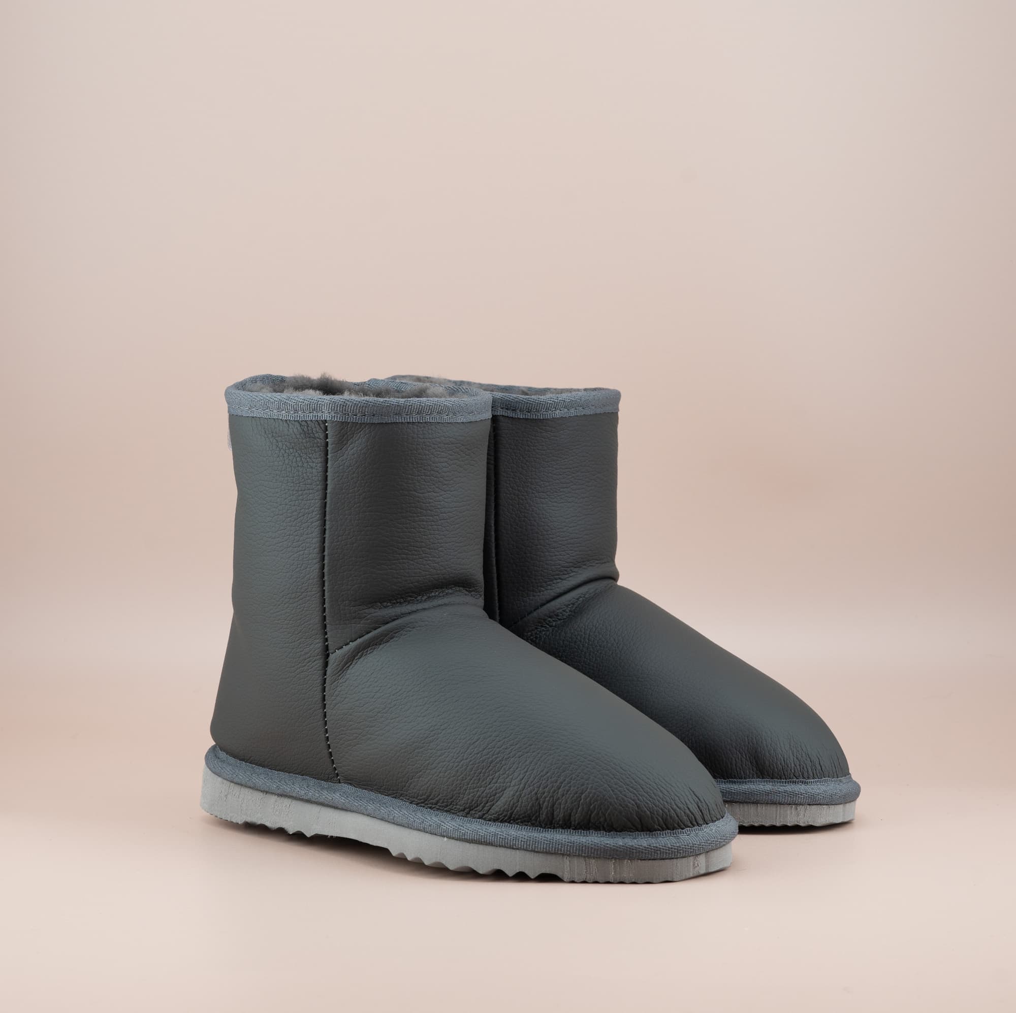 Men's Classic Short ugg boots in genuine leather finish and grey color, front side view. #color_leather grey