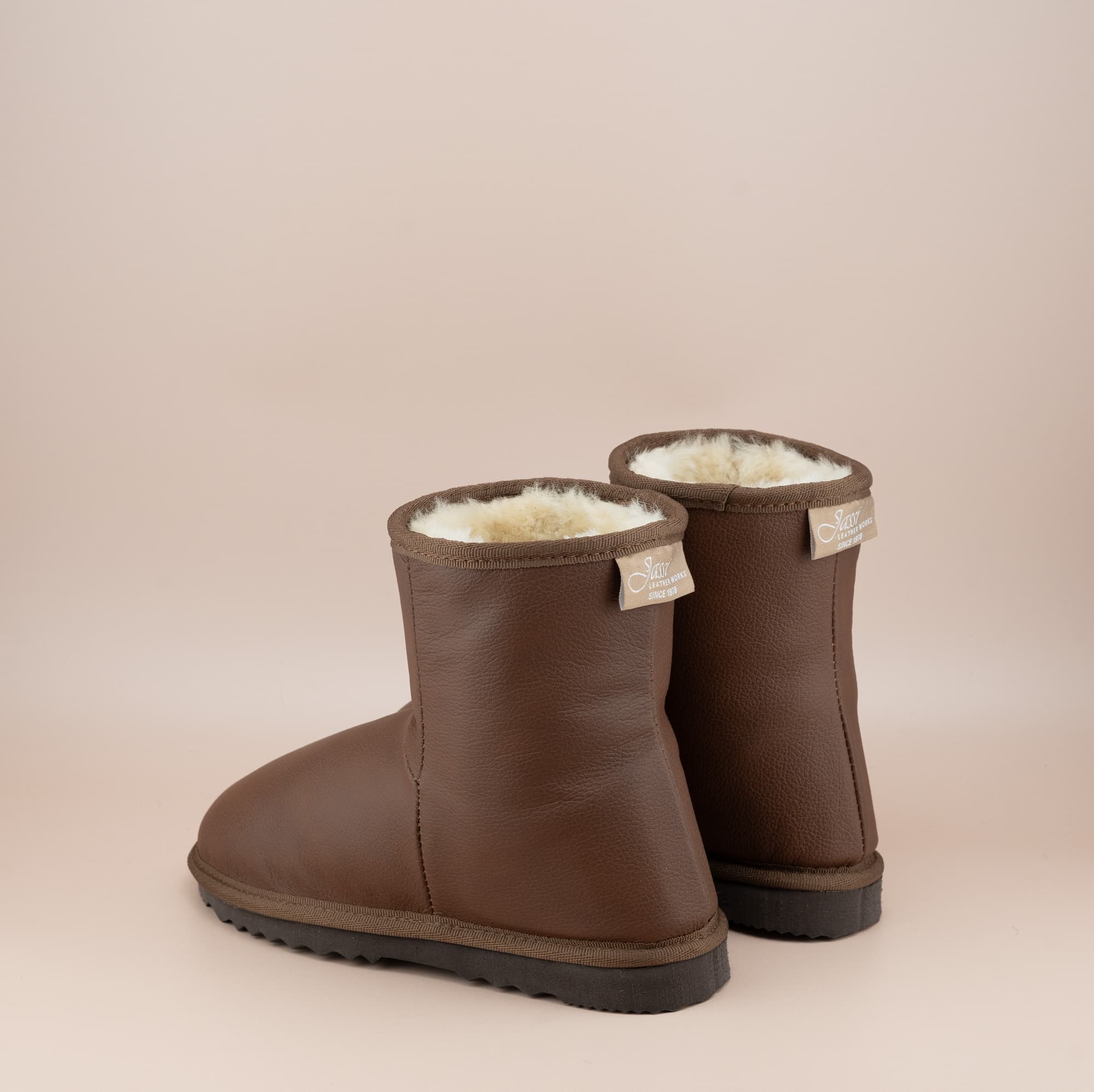 Men's Classic Short ugg boots in genuine leather finish and tan color, back view. #color_leather tan