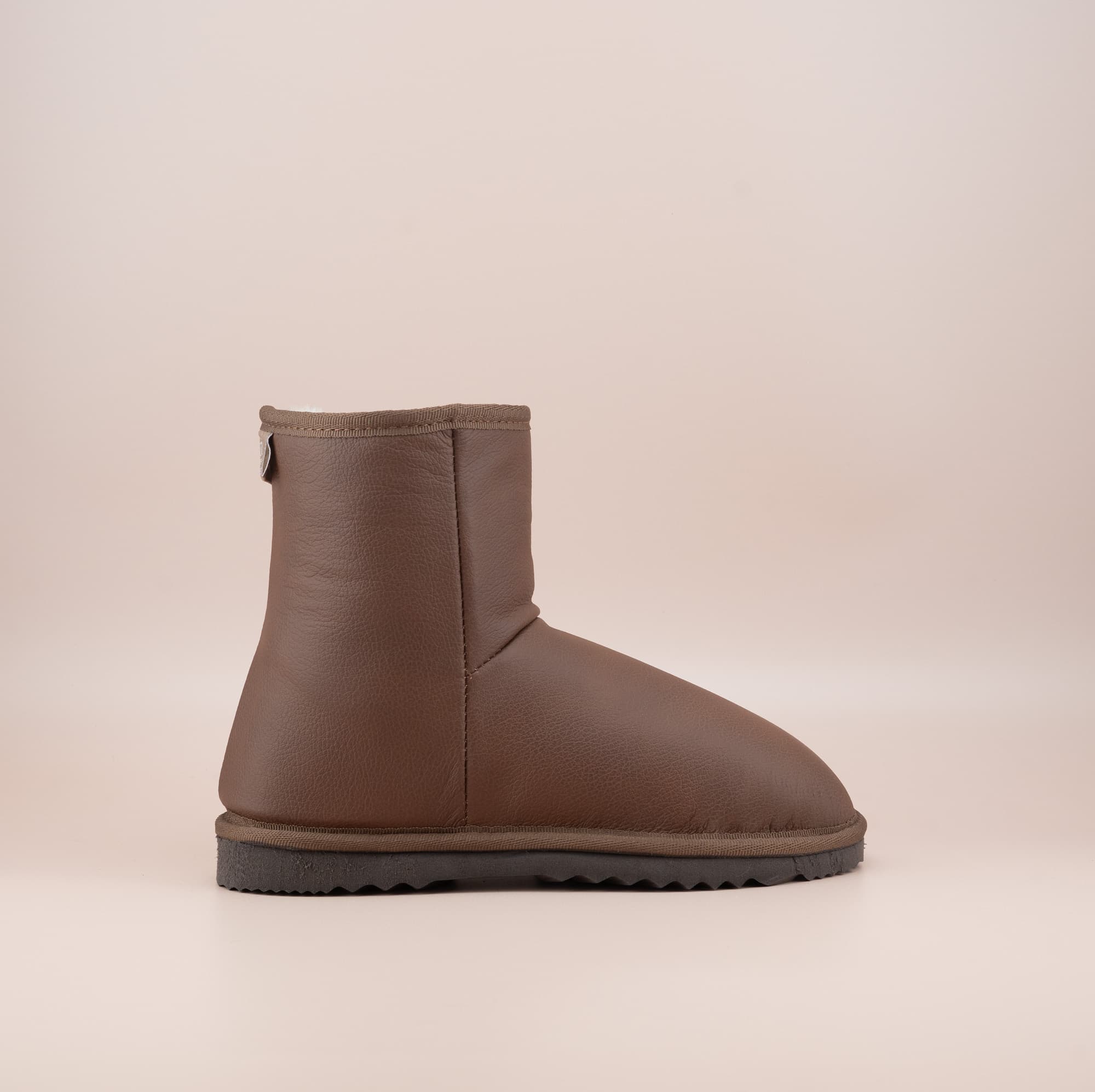 Men's Classic Short ugg boots in genuine leather finish and tan color, side view. #color_leather tan