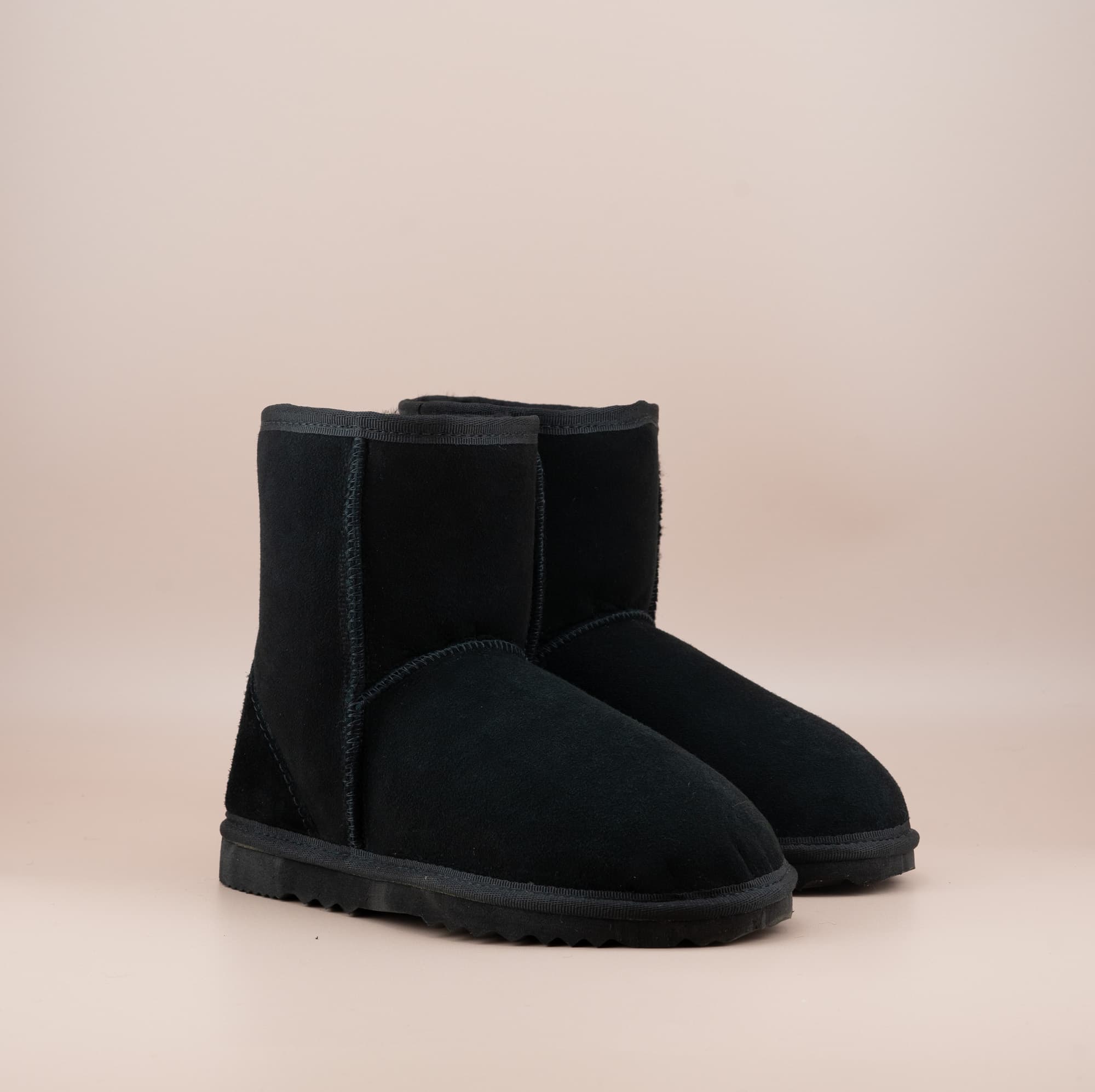 Men's short ugg boot in color black and soft suede finish, front side view. #color_black