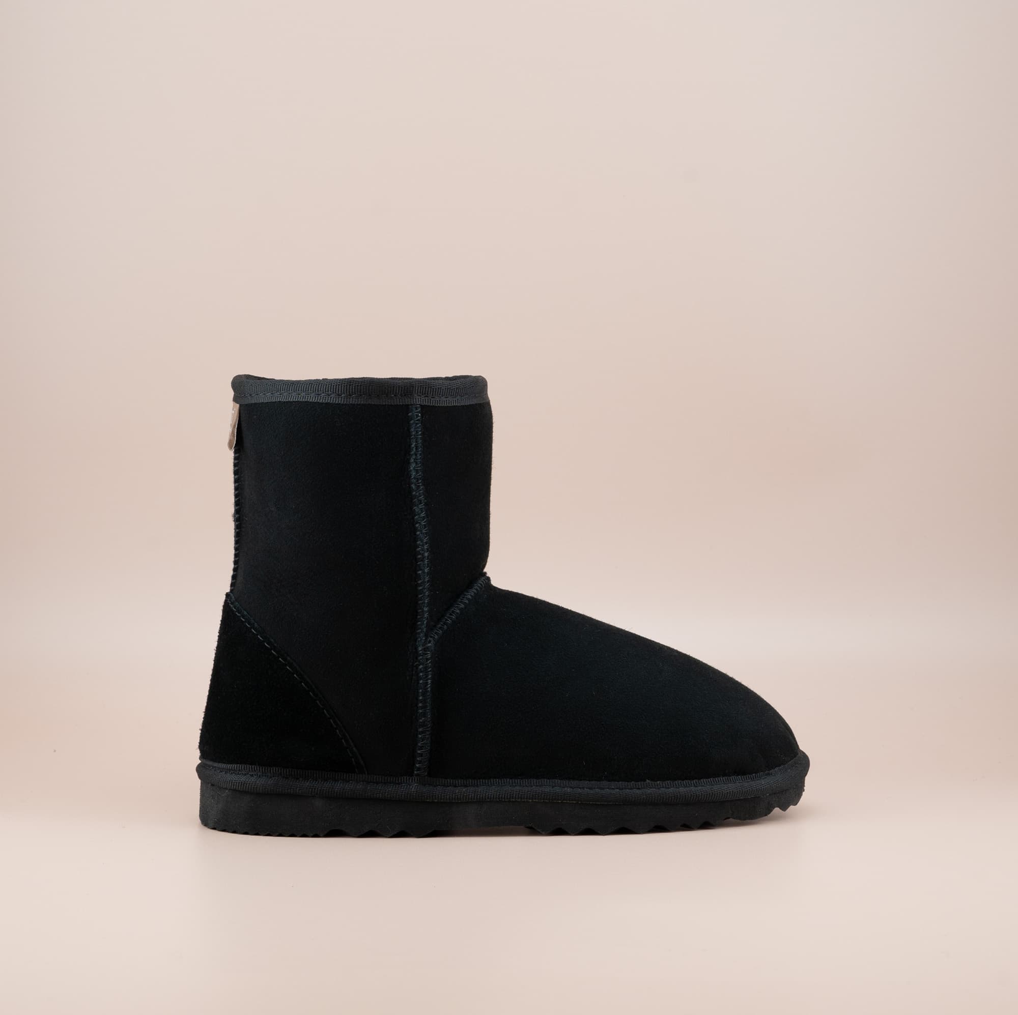 Men's short ugg boot in color black and soft suede finish, side view. #color_black