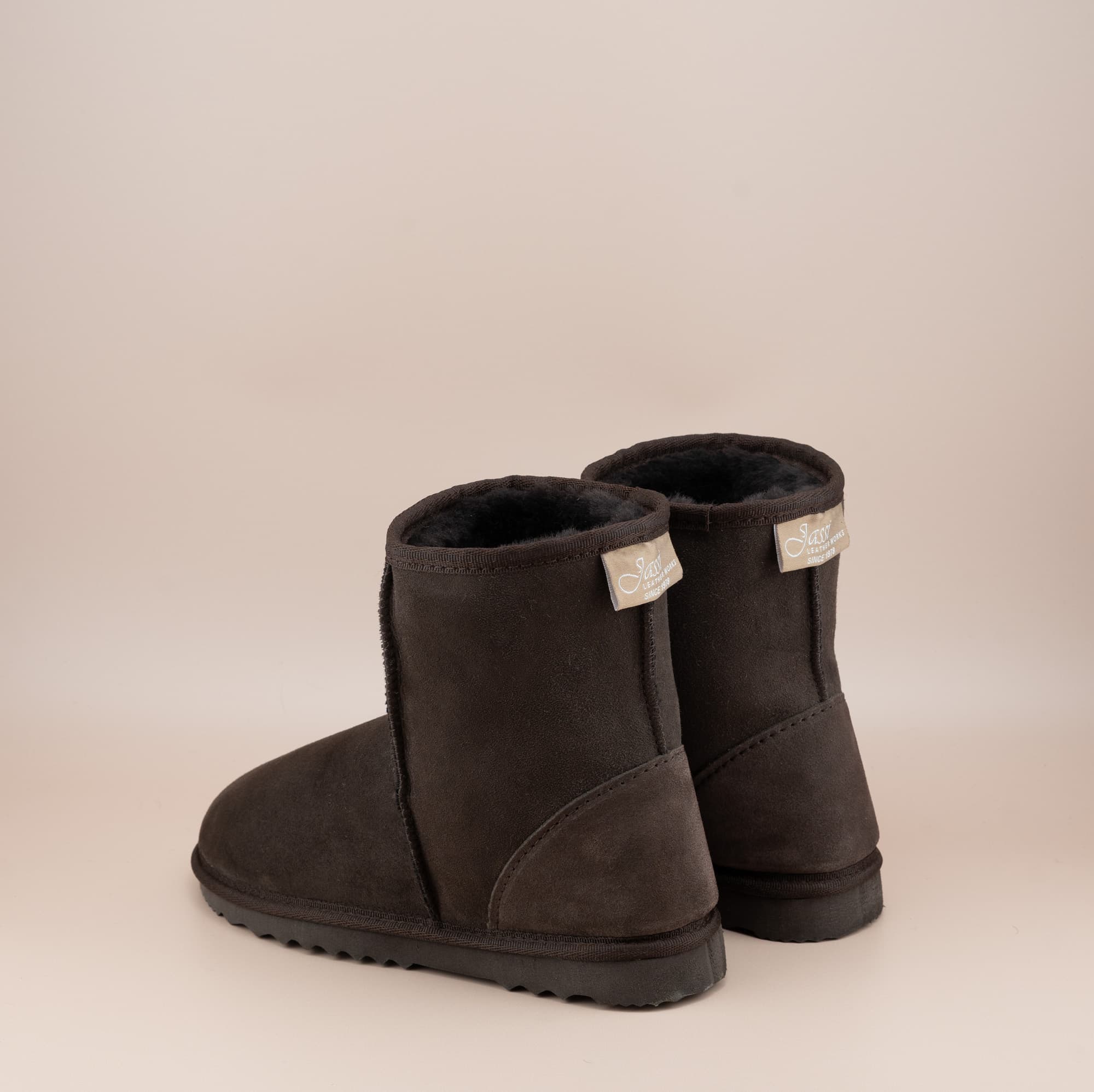 Men's short ugg boot in color chocolate and soft suede finish, back view. #color_chocolate