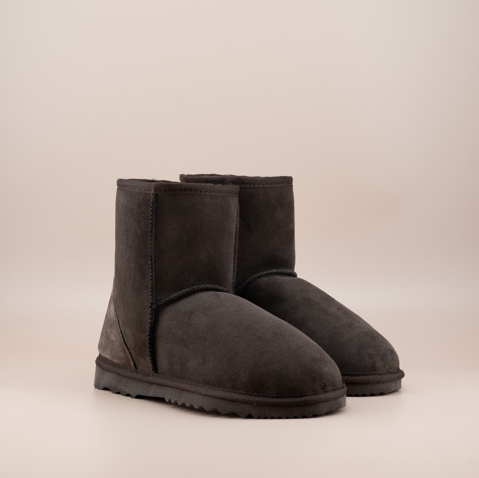 Men's short ugg boot in color chocolate and soft suede finish, front side view. #color_chocolate