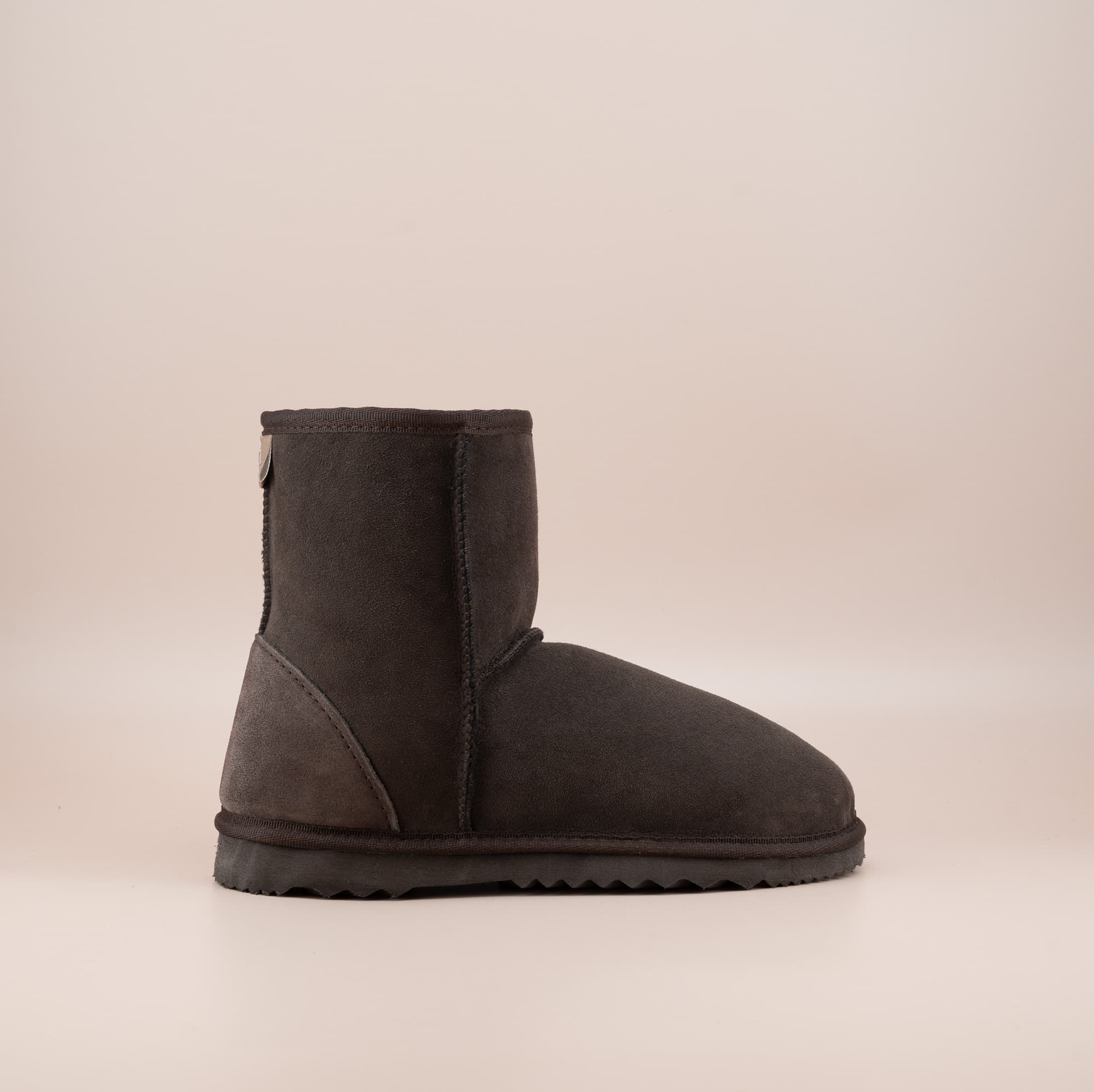 Men's short ugg boot in color chocolate and soft suede finish, side view. #color_chocolate