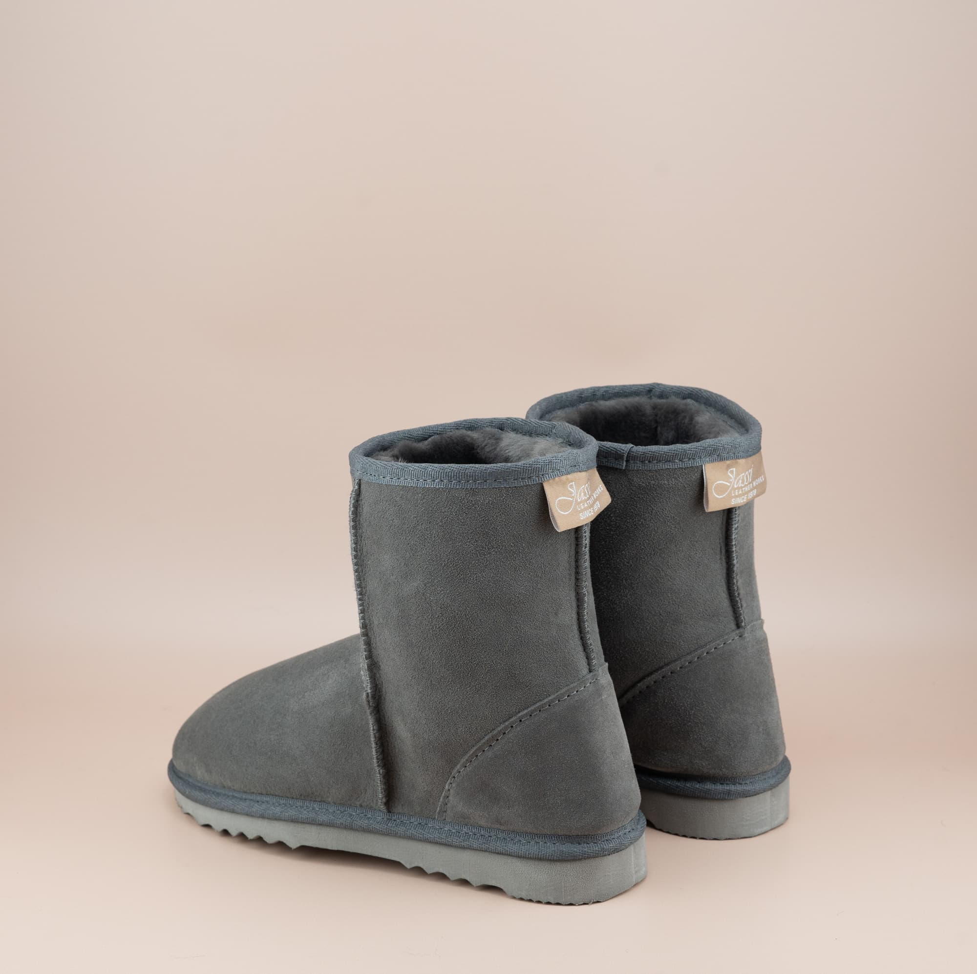 Men's short ugg boot in color grey and soft suede finish, back view. #color_grey