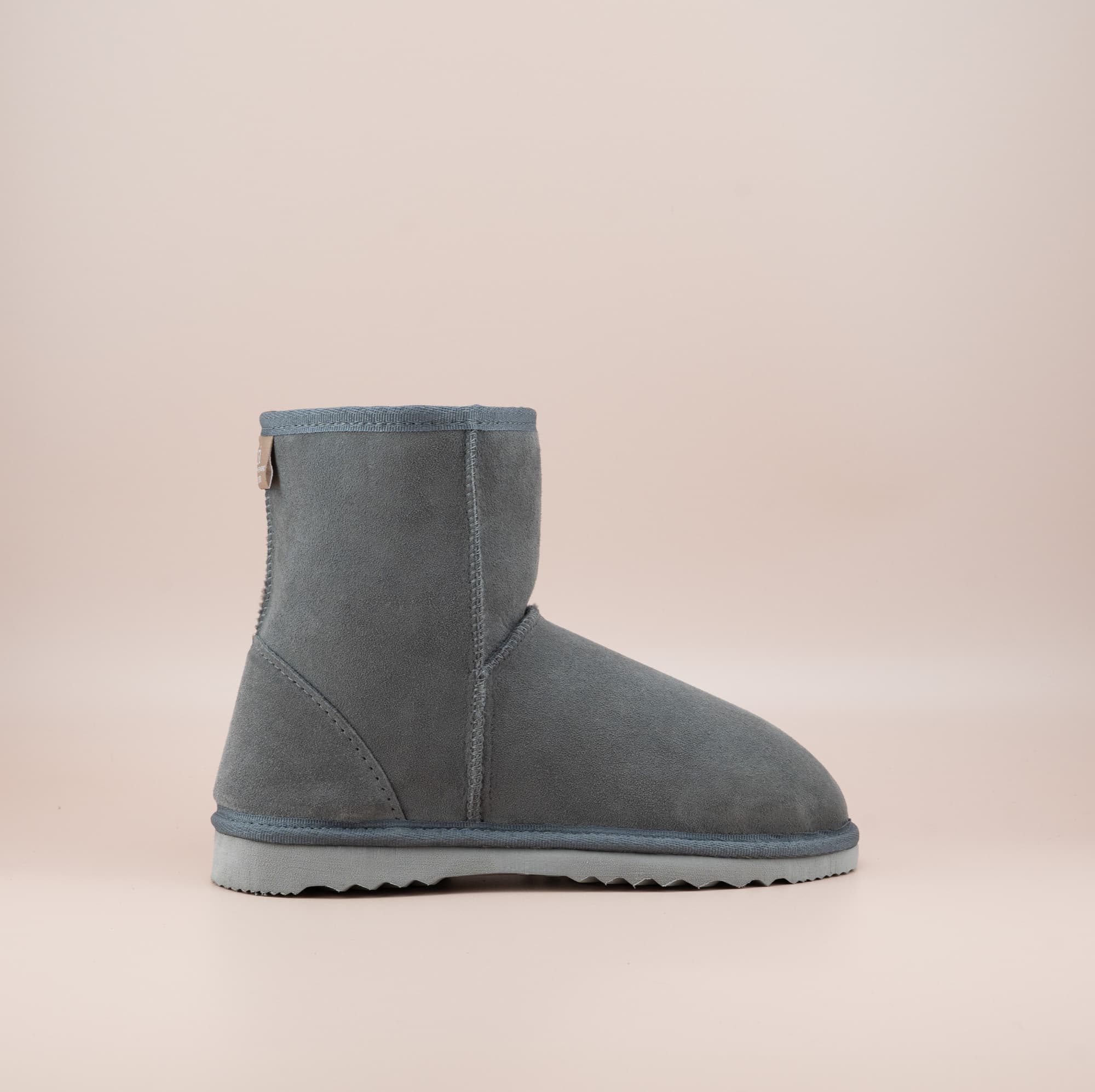 Men's short ugg boot in color grey and soft suede finish, side view. #color_grey