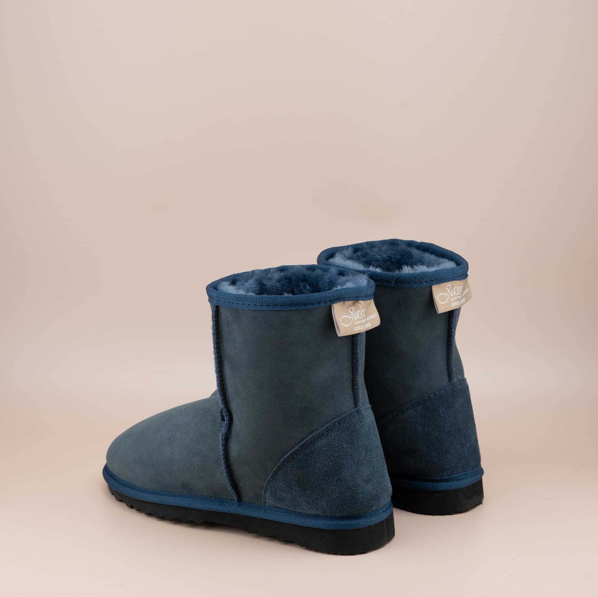 Men's short ugg boot in color navy and soft suede finish, back view. #color_navy