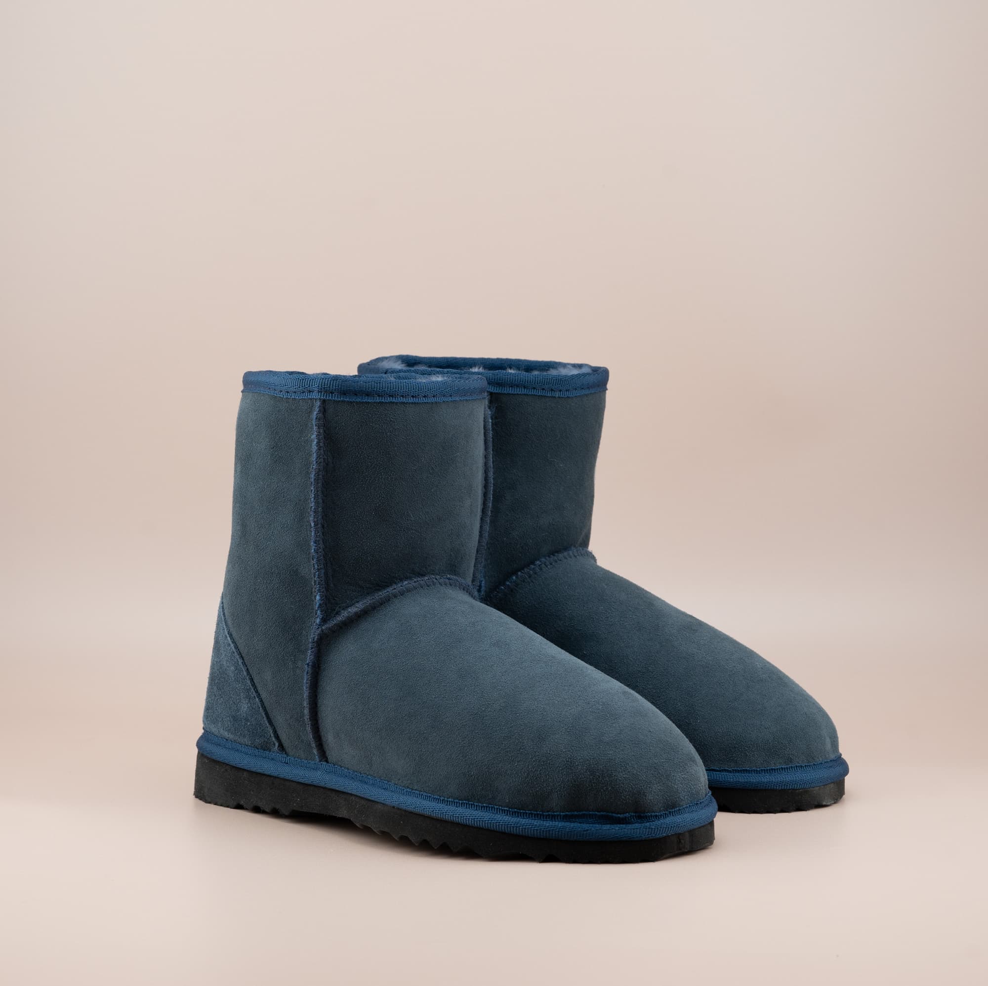 Men's short ugg boot in color navy and soft suede finish, front side view. #color_navy