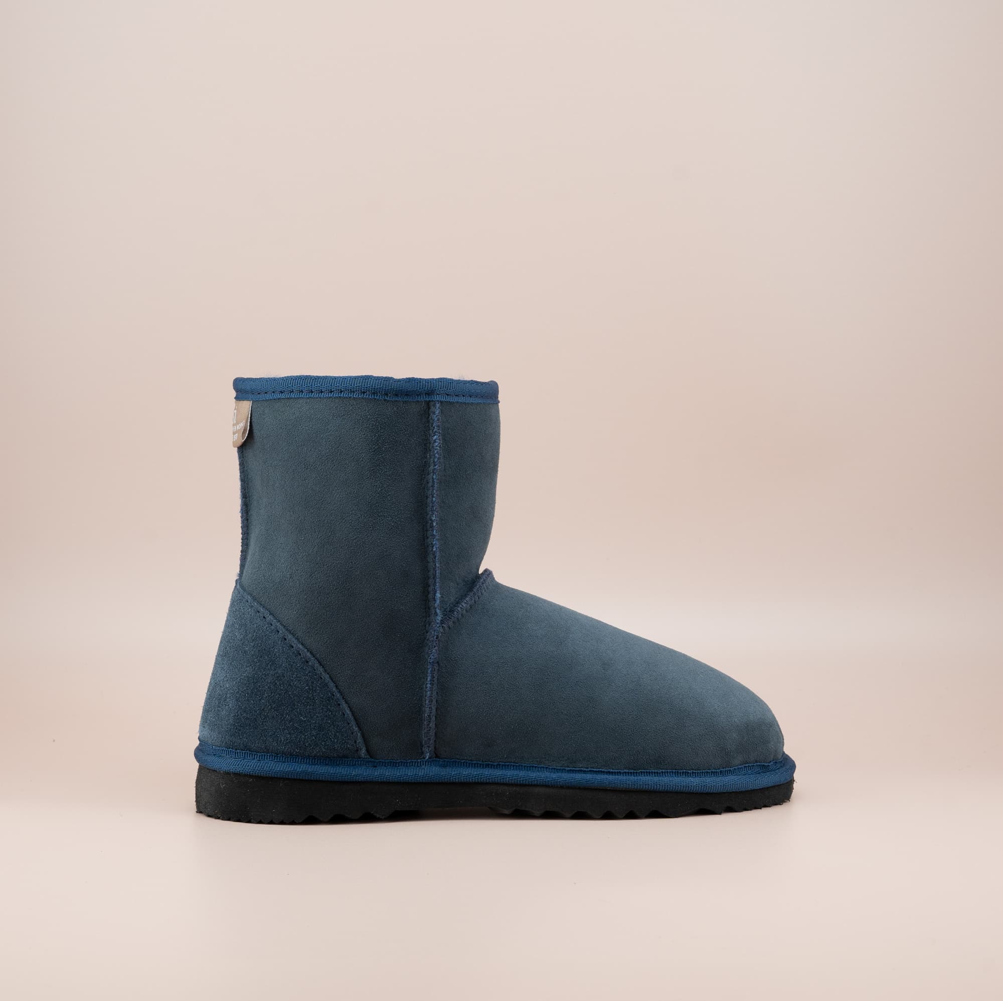 Men's short ugg boot in color navy and soft suede finish, side view. #color_navy