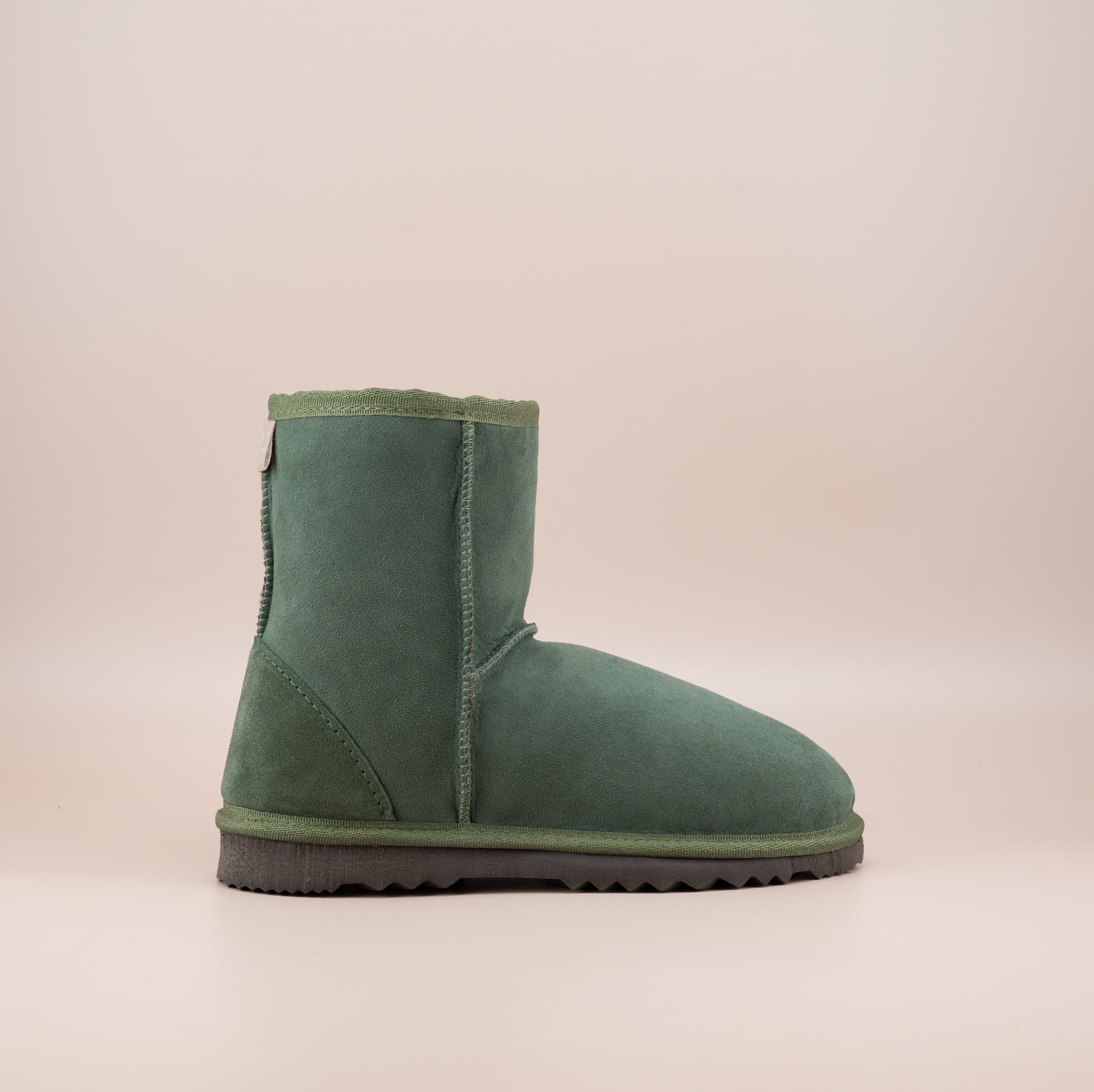 Men's short ugg boot in color olive and soft suede finish, side view. #color_olive