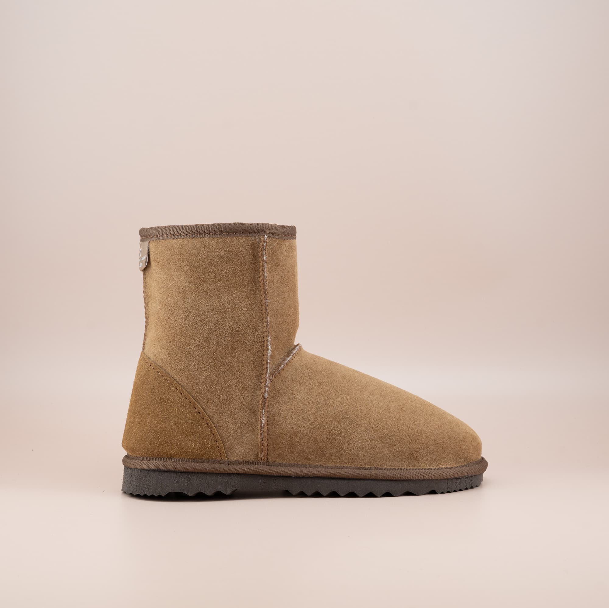 Men's short ugg boot in color tan and soft suede finish, side view. #color_tan