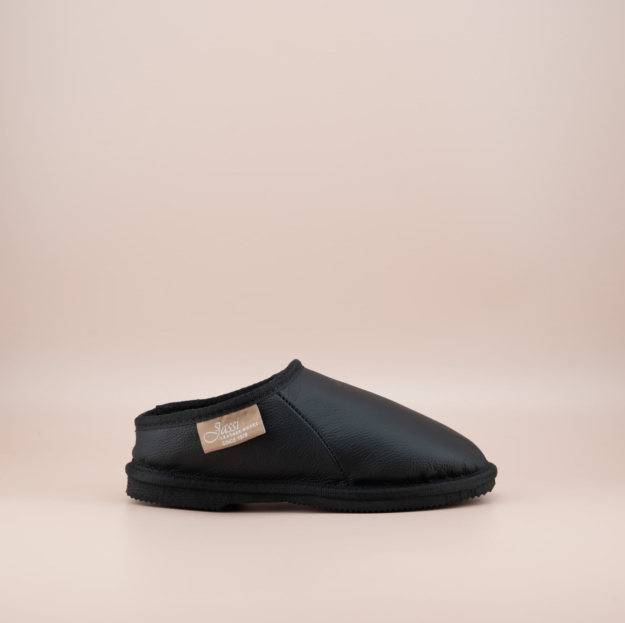 Men's ugg mewels with a leather finish in black, side view. #color_leather black