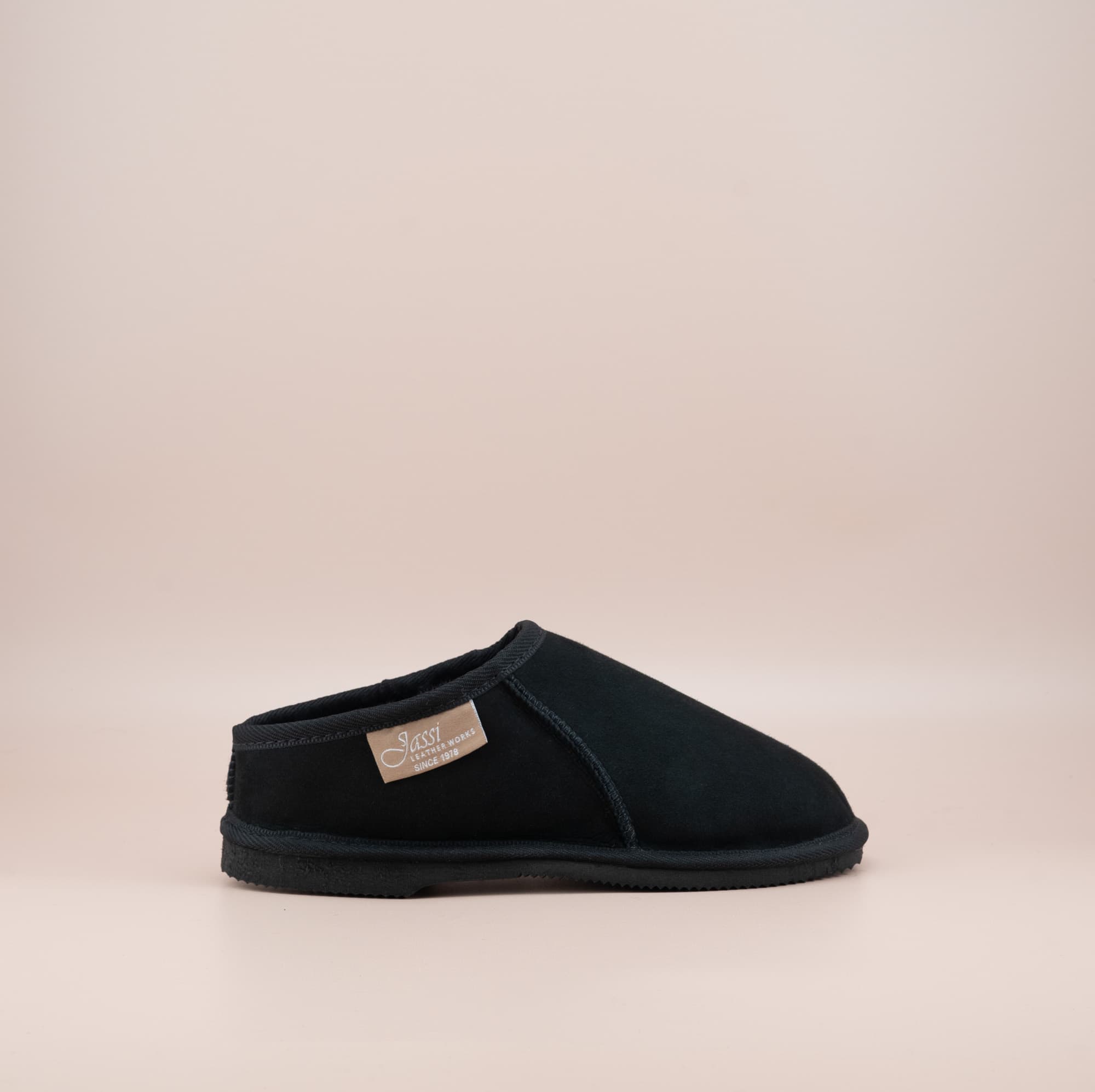 Men's ugg mewels with a suede finish in black, side view. #color_black