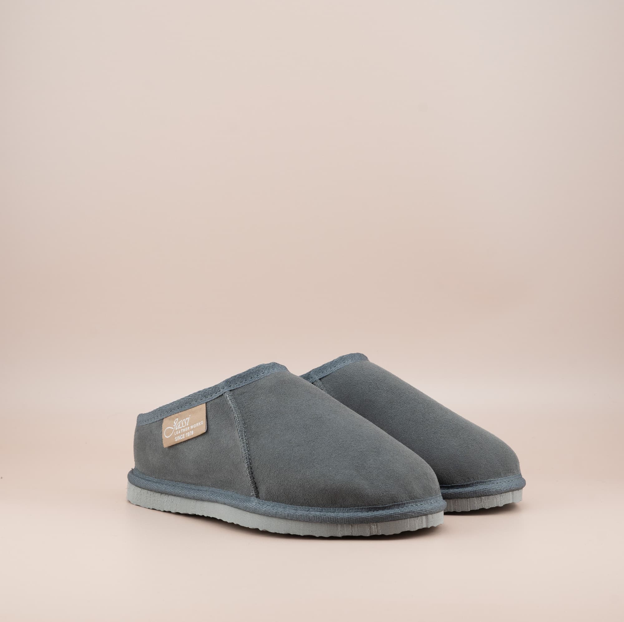 Men's ugg mewels with a suede finish in grey, front side view. #color_grey