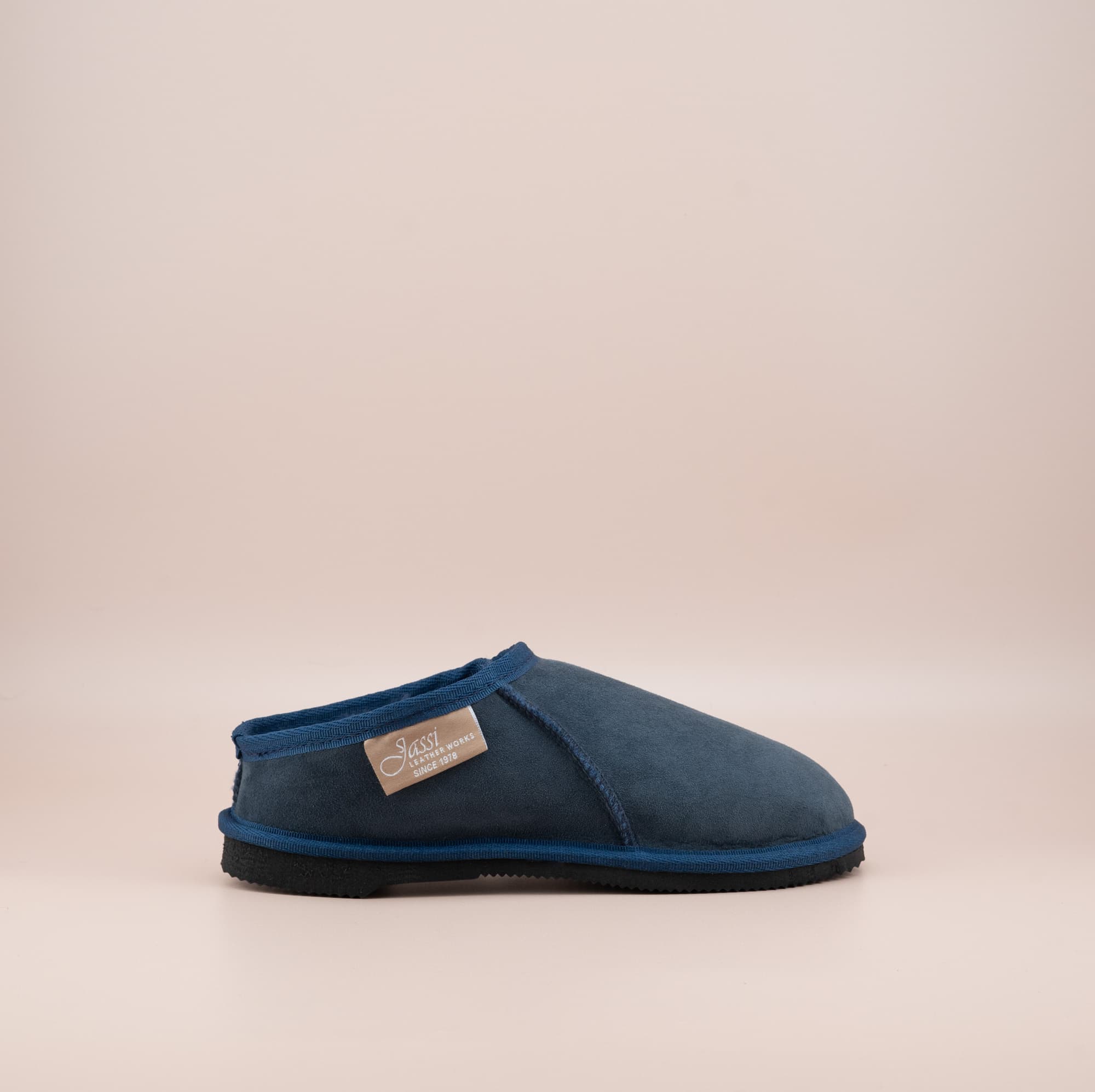 Men's ugg mewels with a suede finish in navy, side view. #color_navy