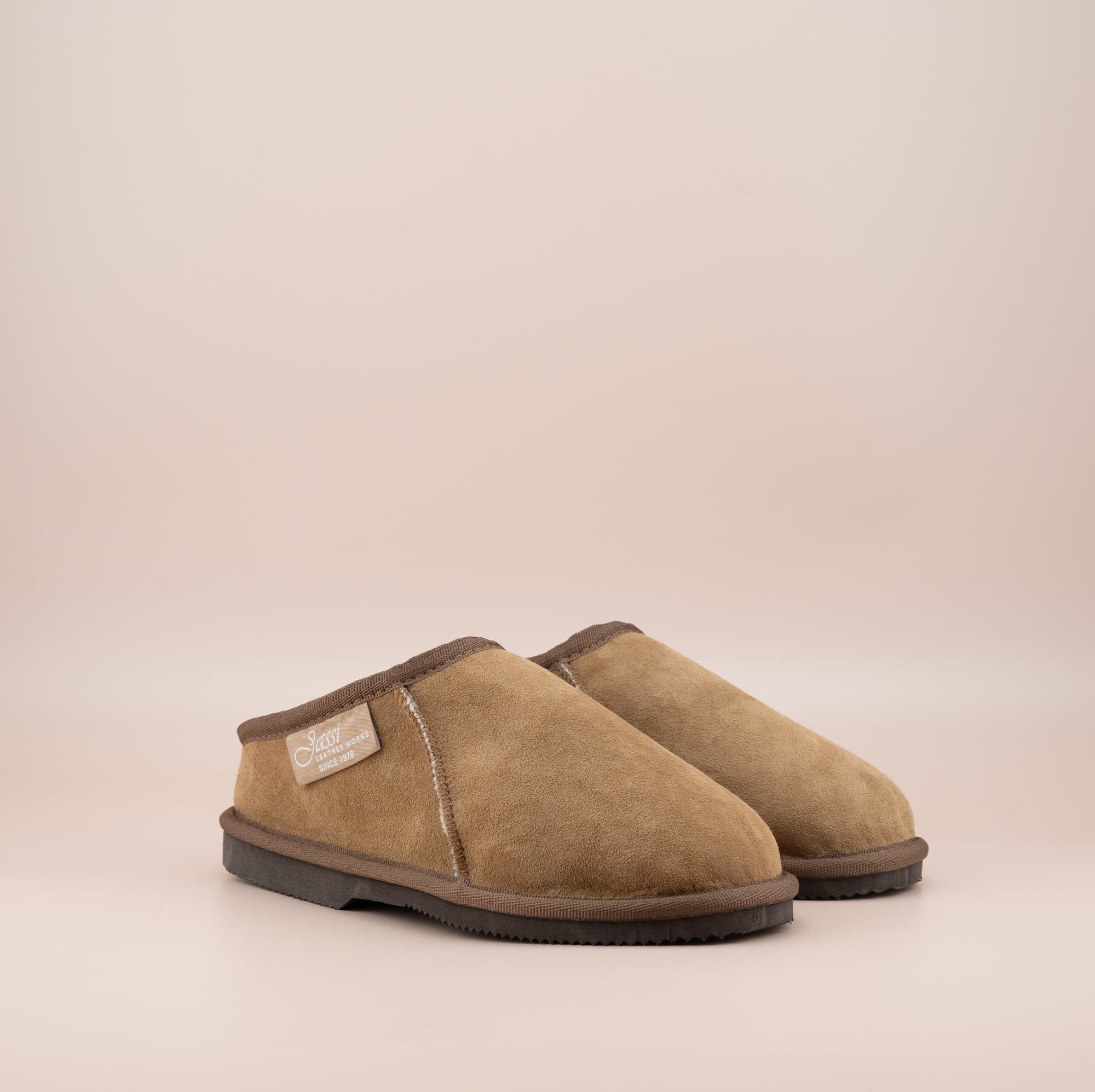 Men's ugg mewels with a suede finish in tan, front side view. #color_tan