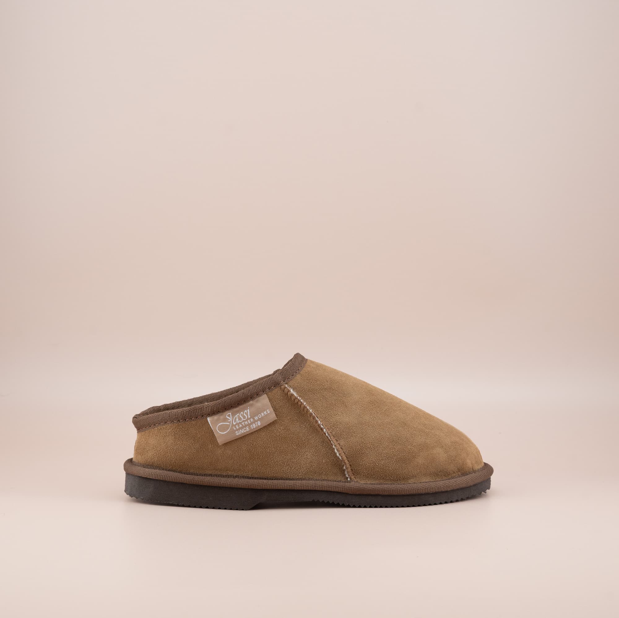 Men's ugg mewels with a suede finish in tan, side view. #color_tan