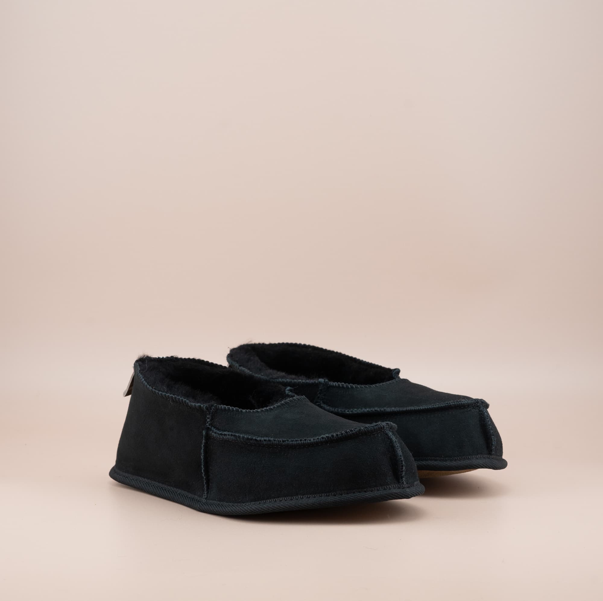 Men's ugg moccasins with a suede finish in black, side view. #color_black