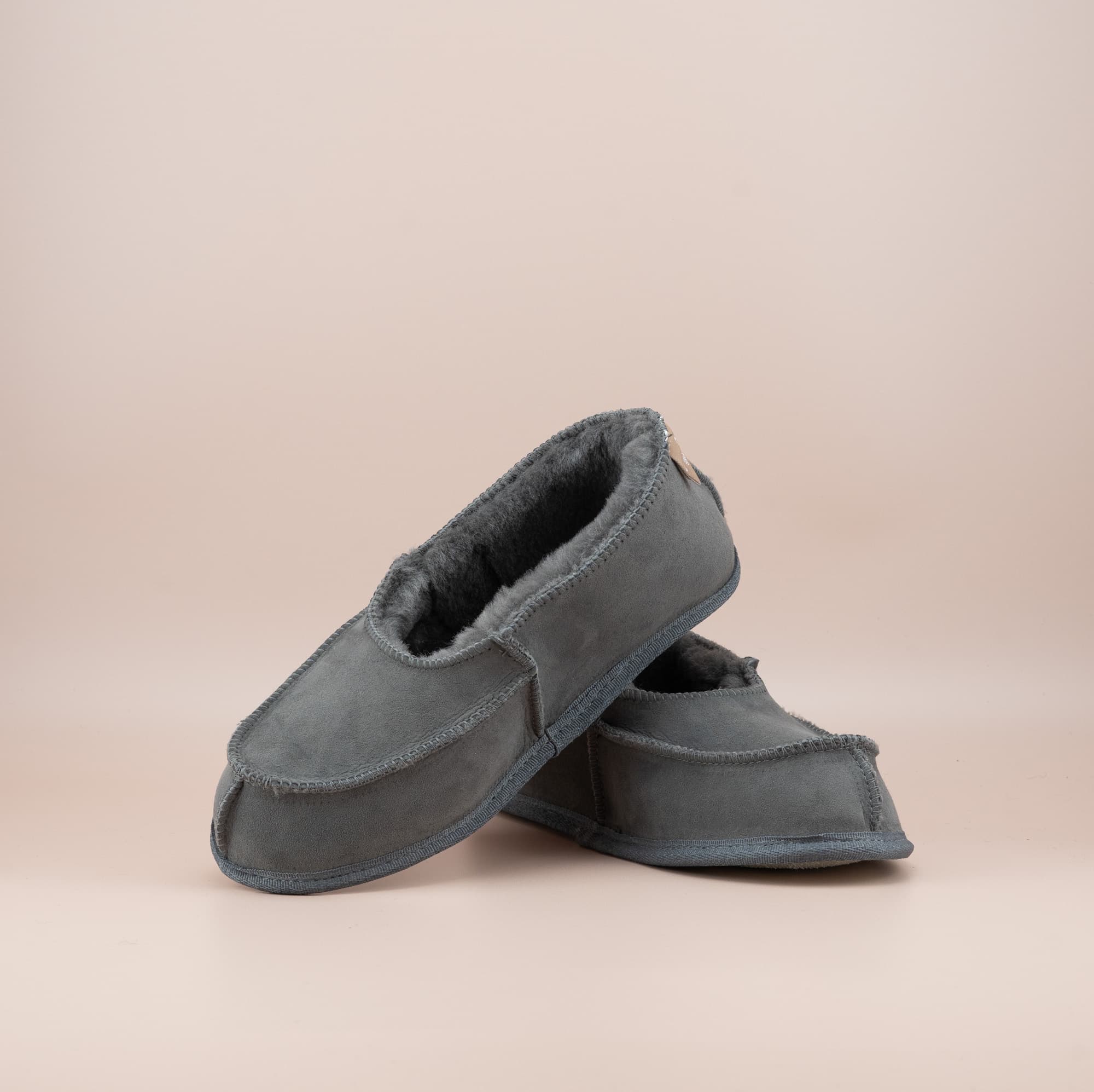 Men's ugg moccasins with a suede finish in grey, front and side view. #color_grey