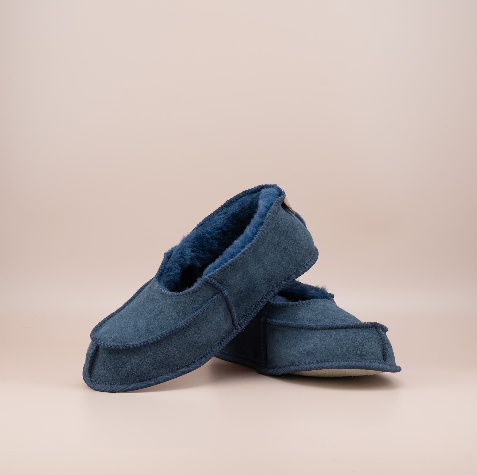 Men's ugg moccasins with a suede finish in navy, front and side view. #color_navy