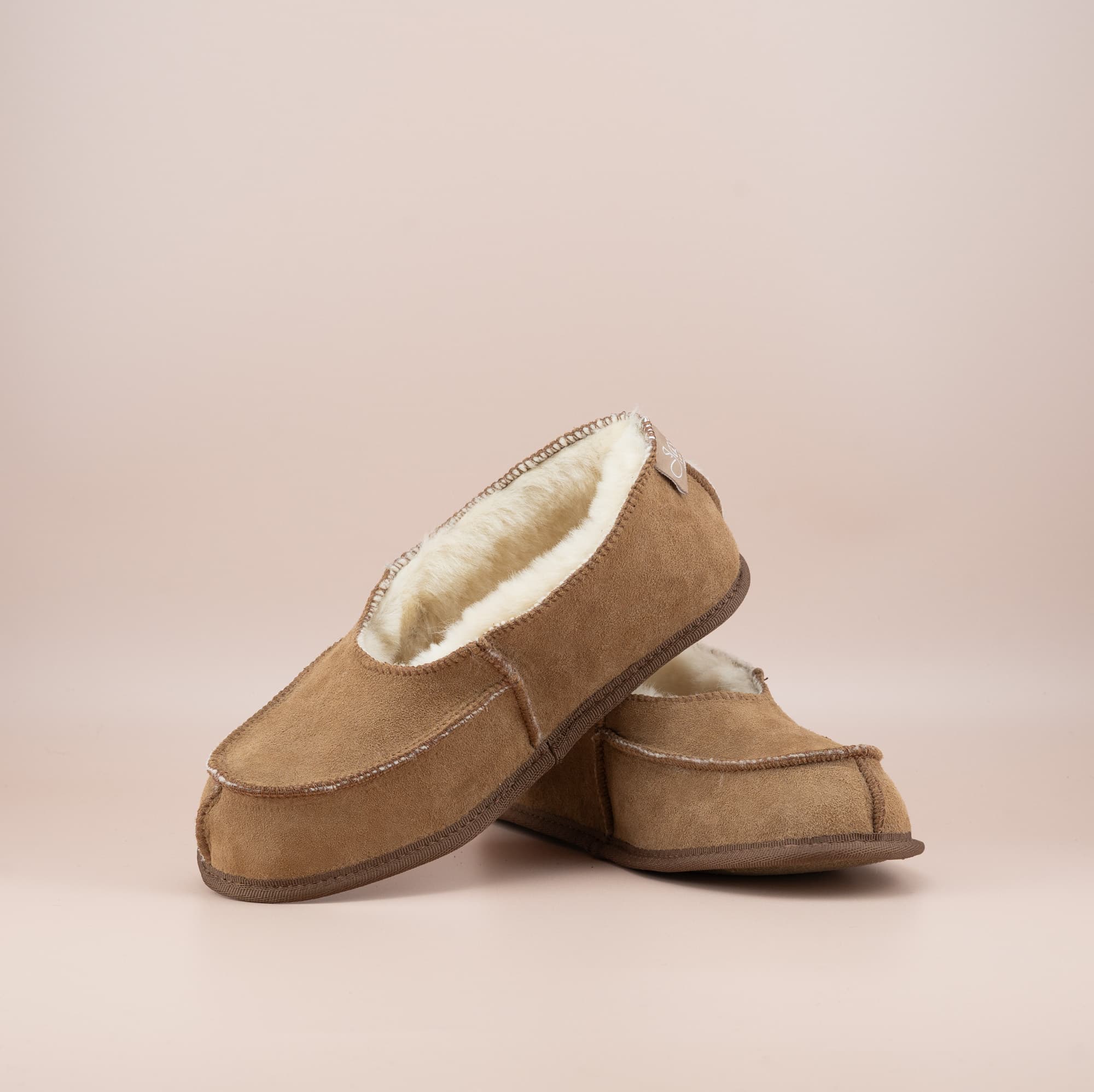 Men's ugg moccasins with a suede finish in tan, front and side view. #color_tan