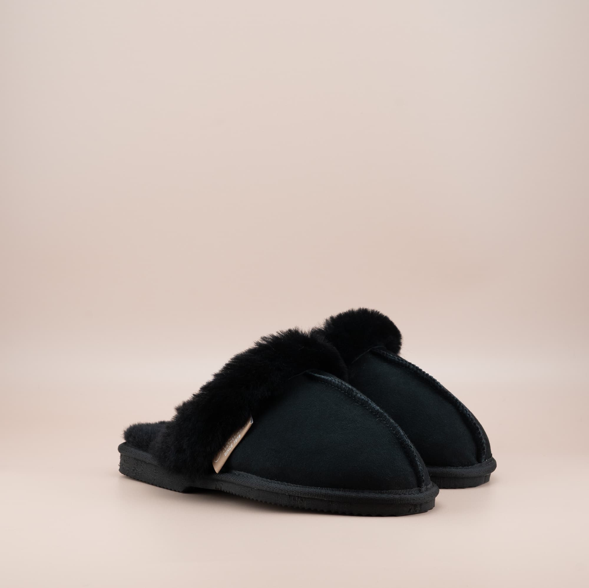 Men's ugg scuffs with a suede finish in black and wool turn, side view of the pair. #color_black