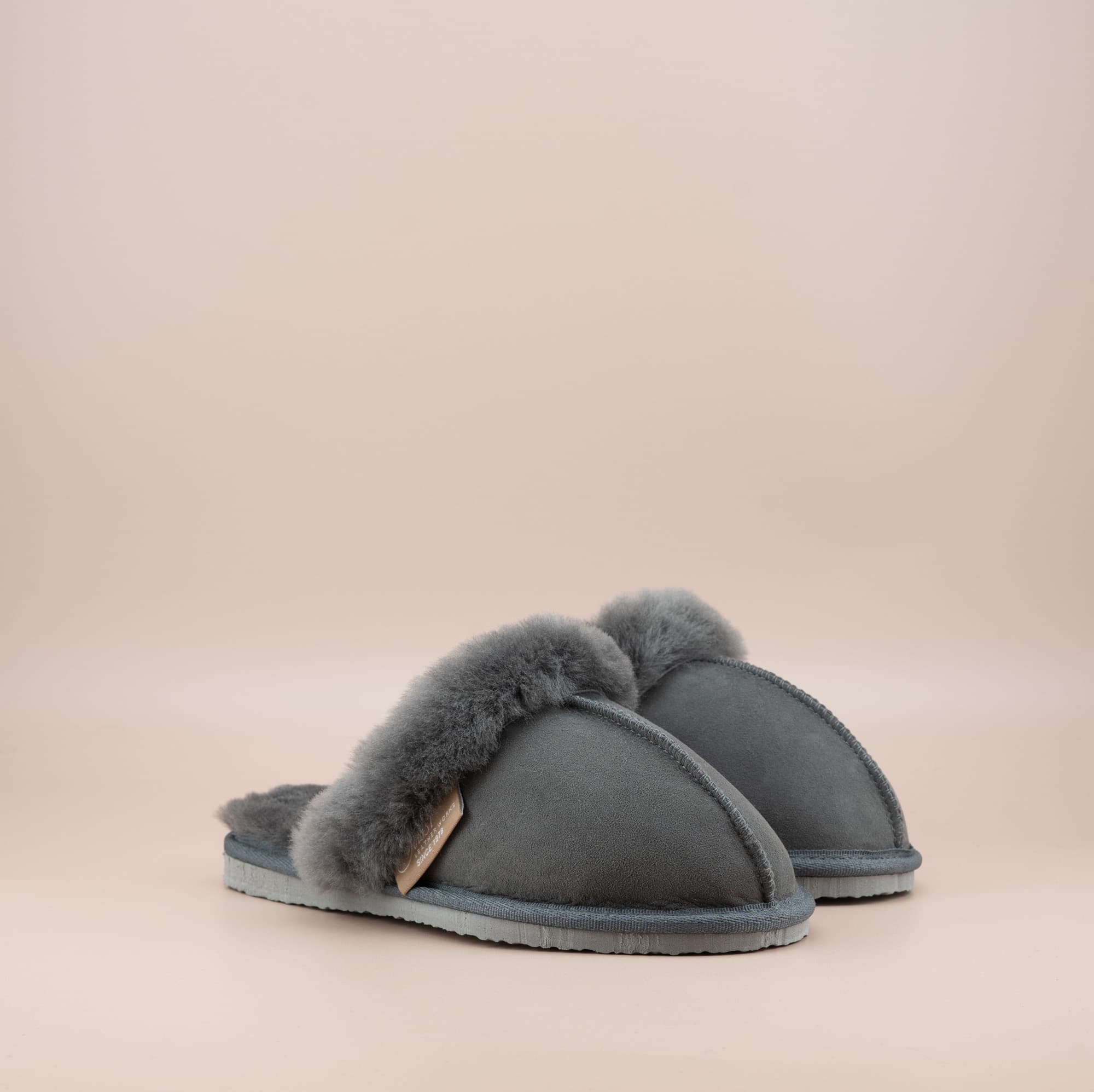 Men's ugg scuffs with a suede finish in grey and wool turn, side view of the pair. #color_grey