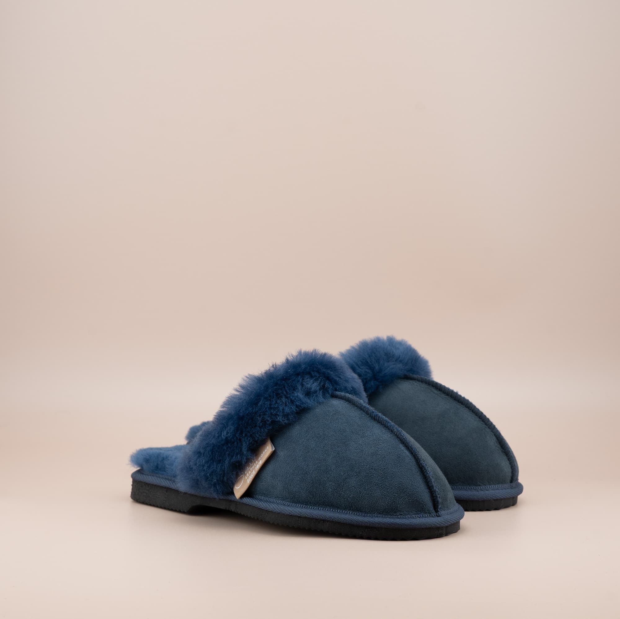 Men's ugg scuffs with a suede finish in navy and wool turn, side view of the pair. #color_navy