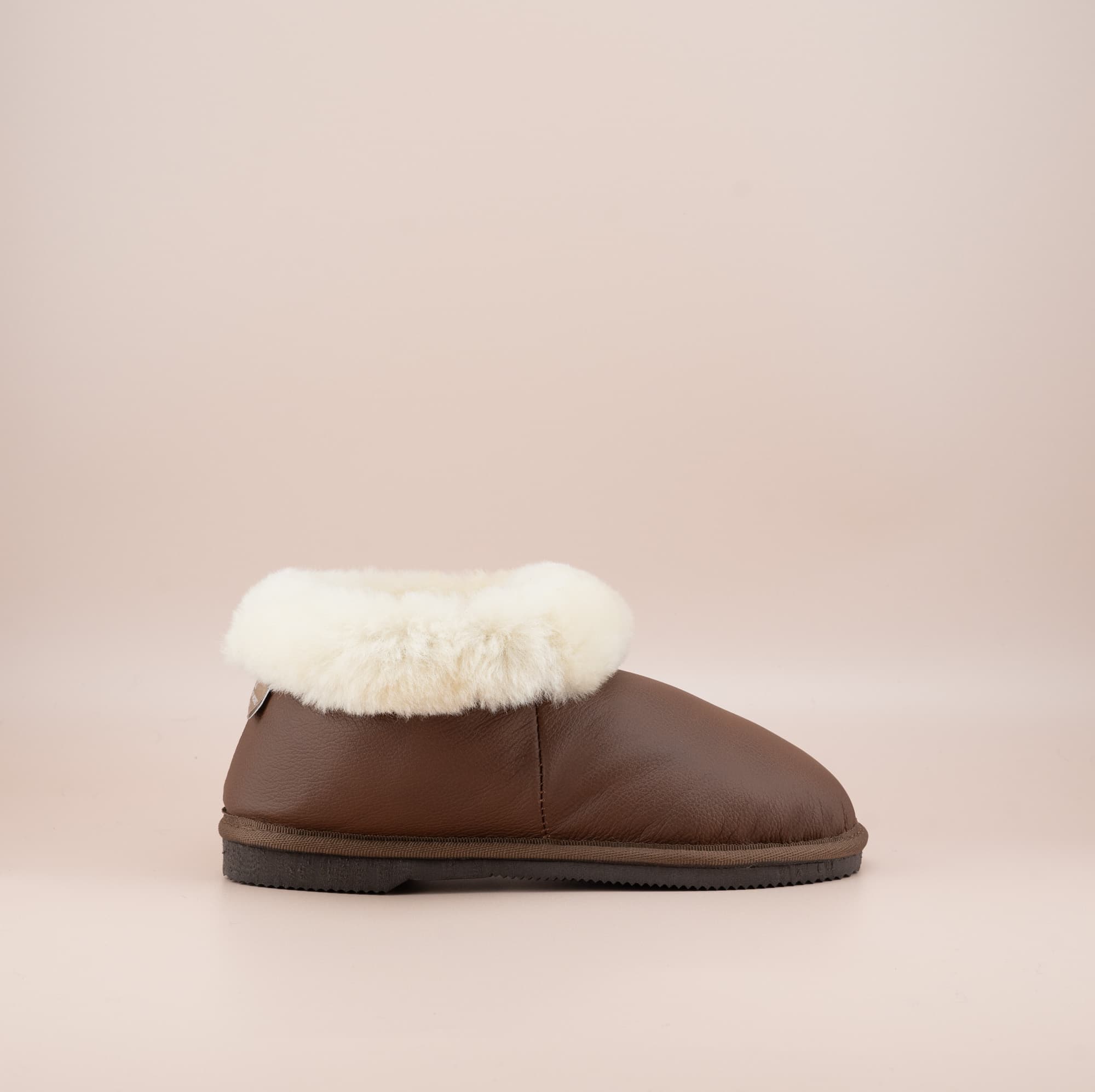 Men's ugg slippers with a genuine leather finish in tan and wool turn,single side view. #color_leather tan